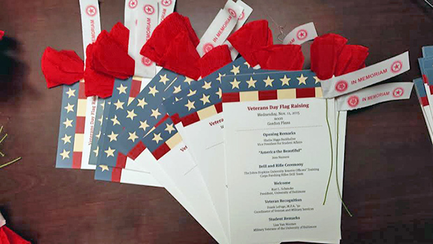 poppies and programs from the veterans day flag raising ceremony