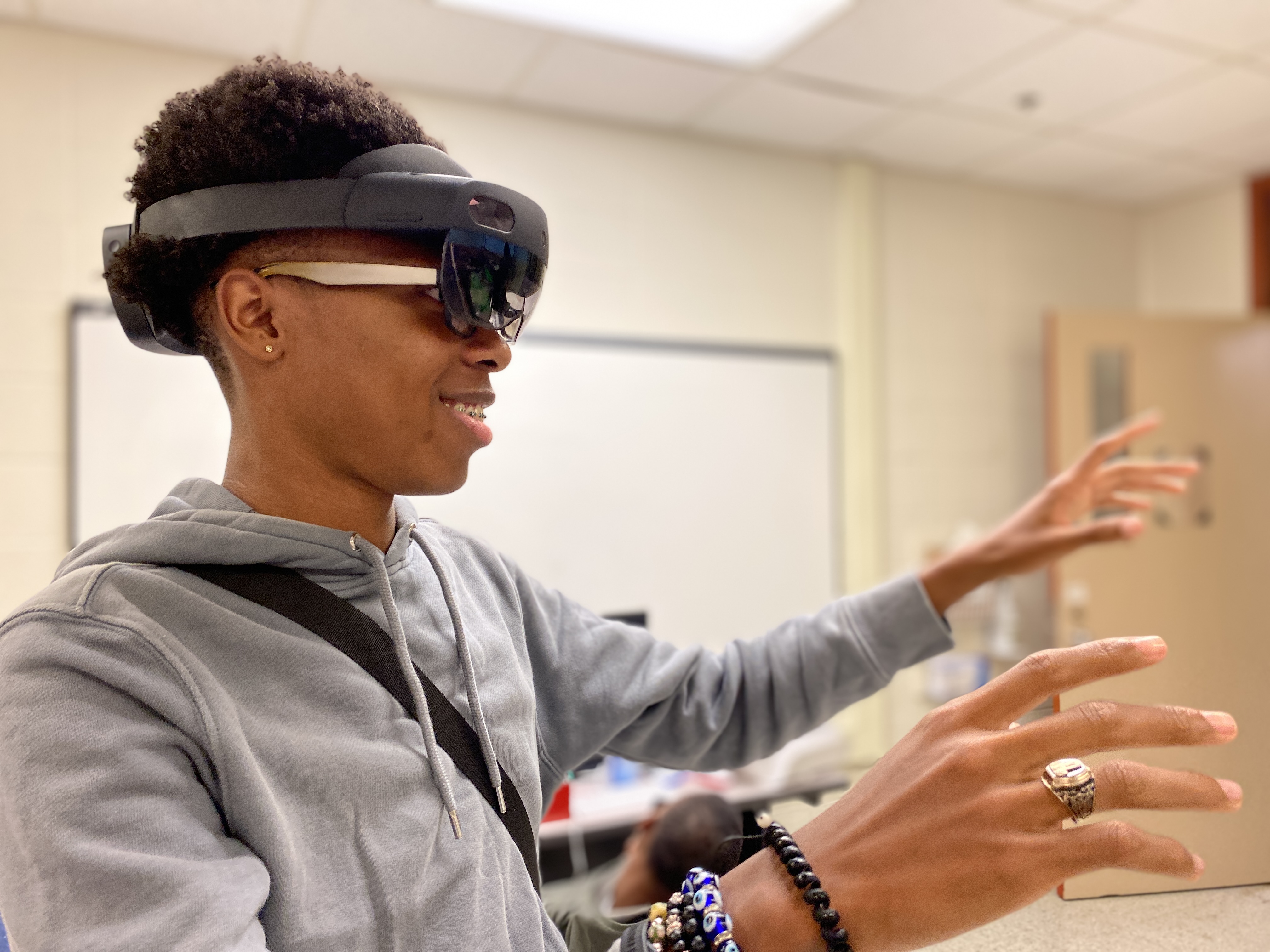 A student tries augmented reality while wearing a headset