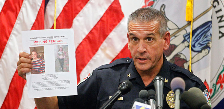 Longo holds up Graham's missing-person poster