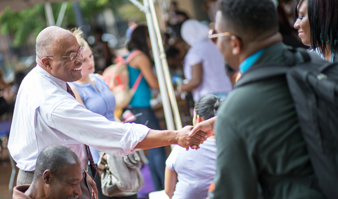 President Schmoke greets students during Welcome Weeks 2014 