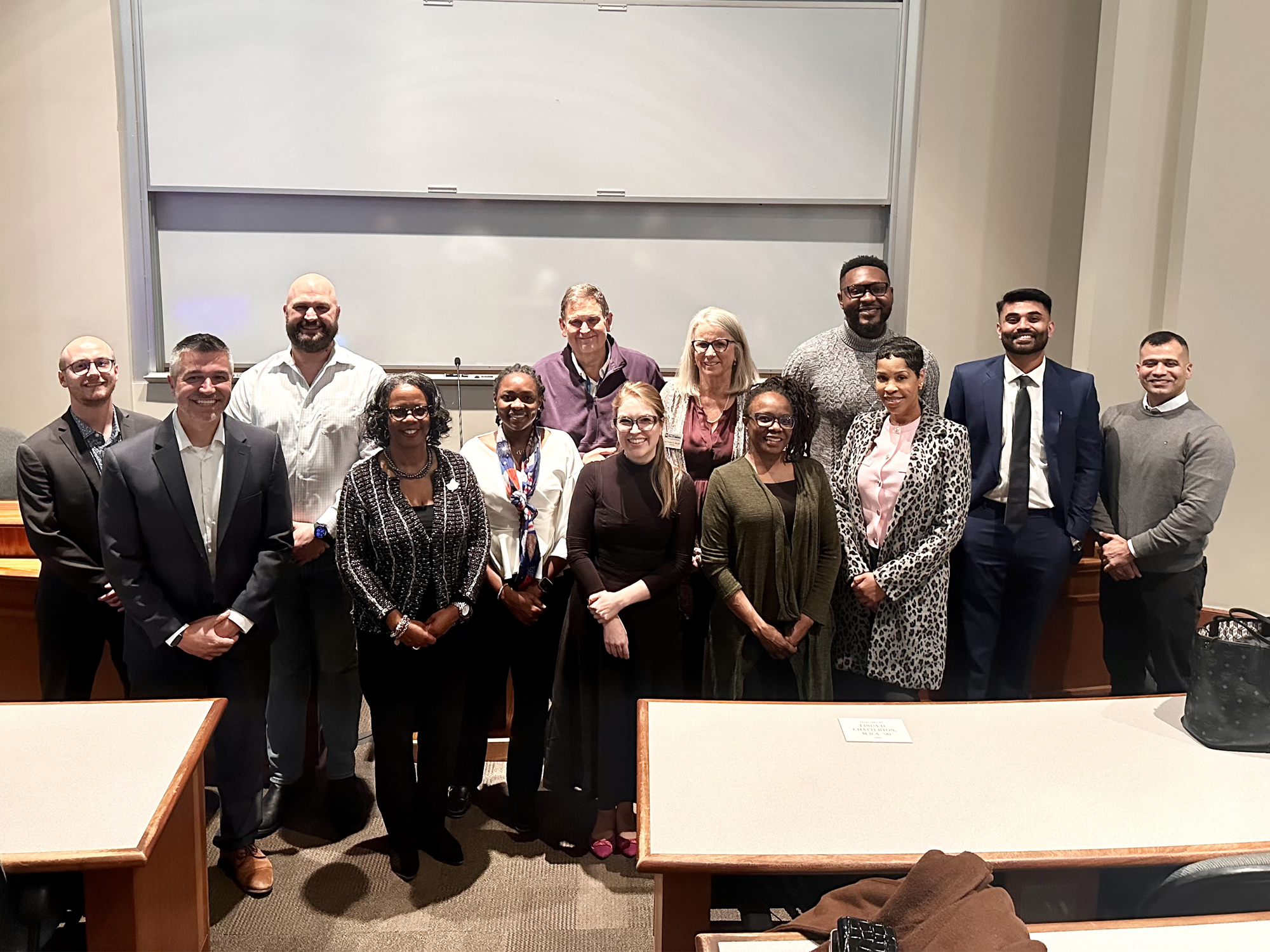 A group of accounting faculty and alumni pose for a photo at Back to UBalt Night