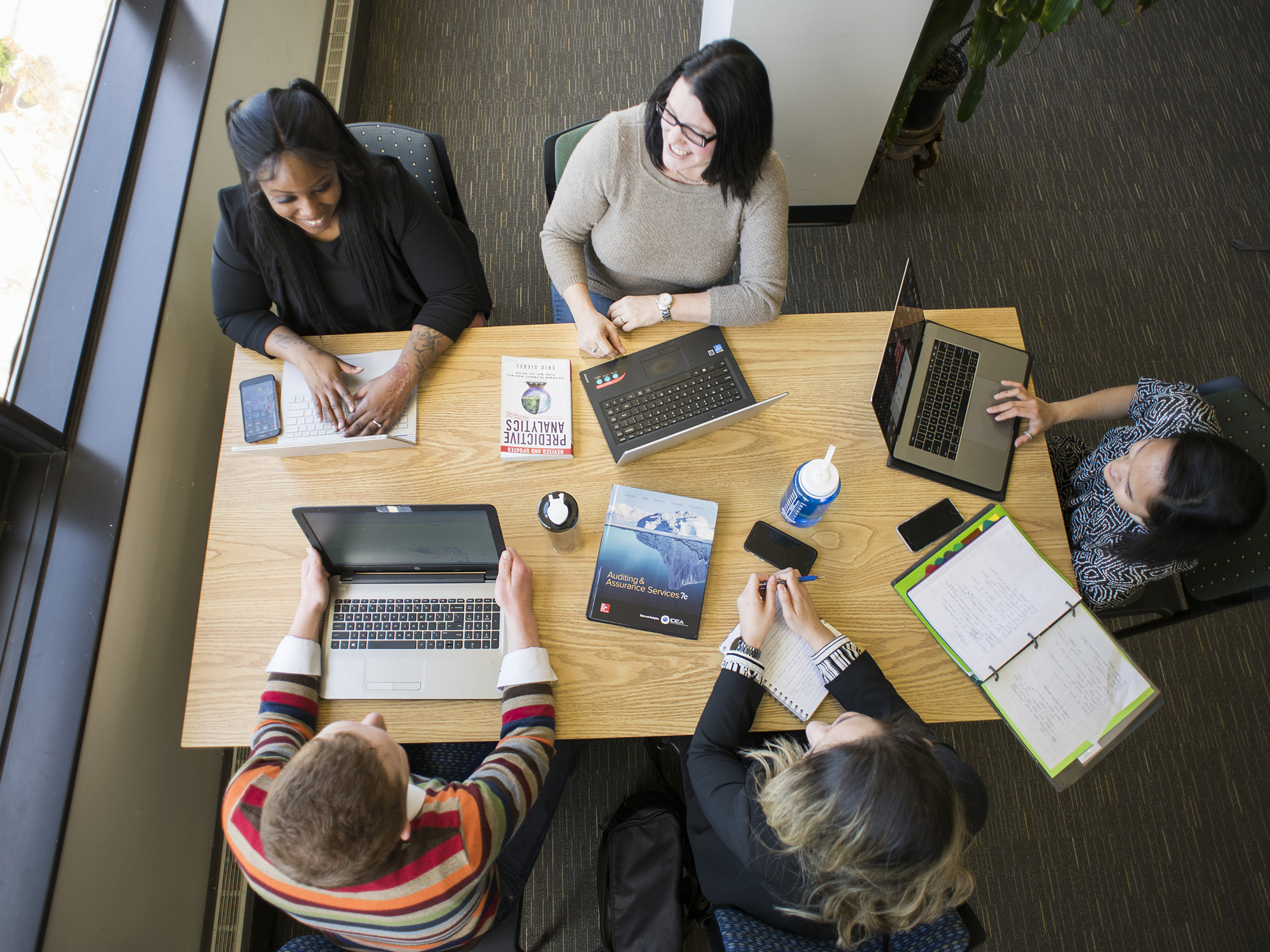 five students studying at a table