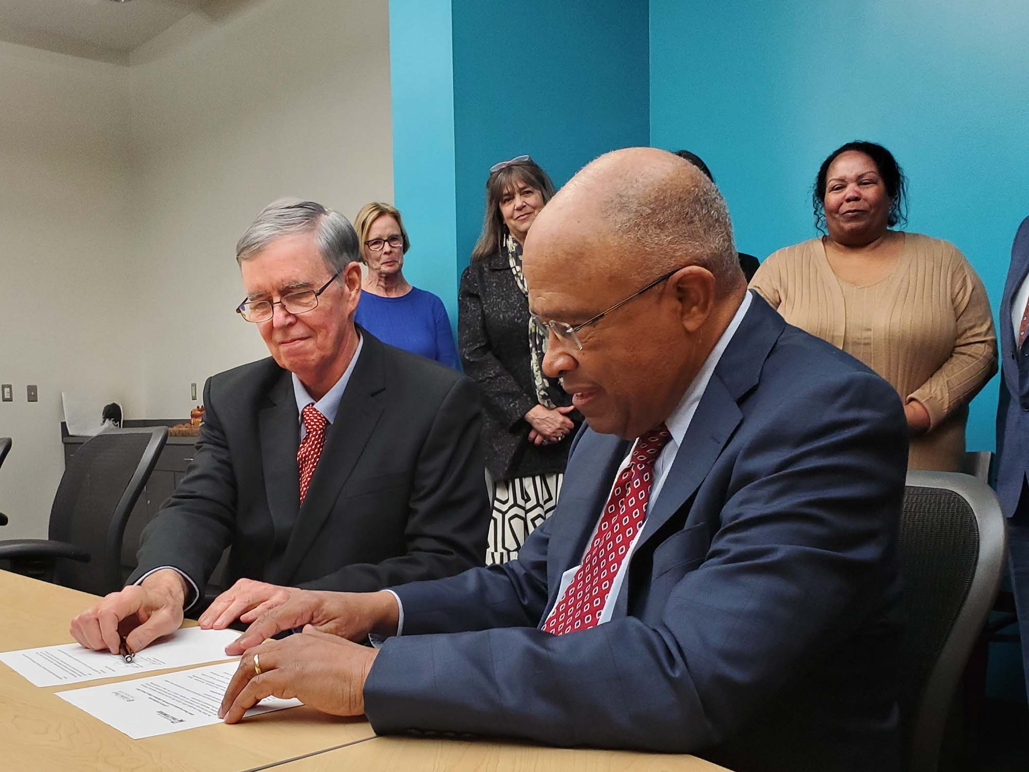 Schmoke and Flynn sign partnership agreement