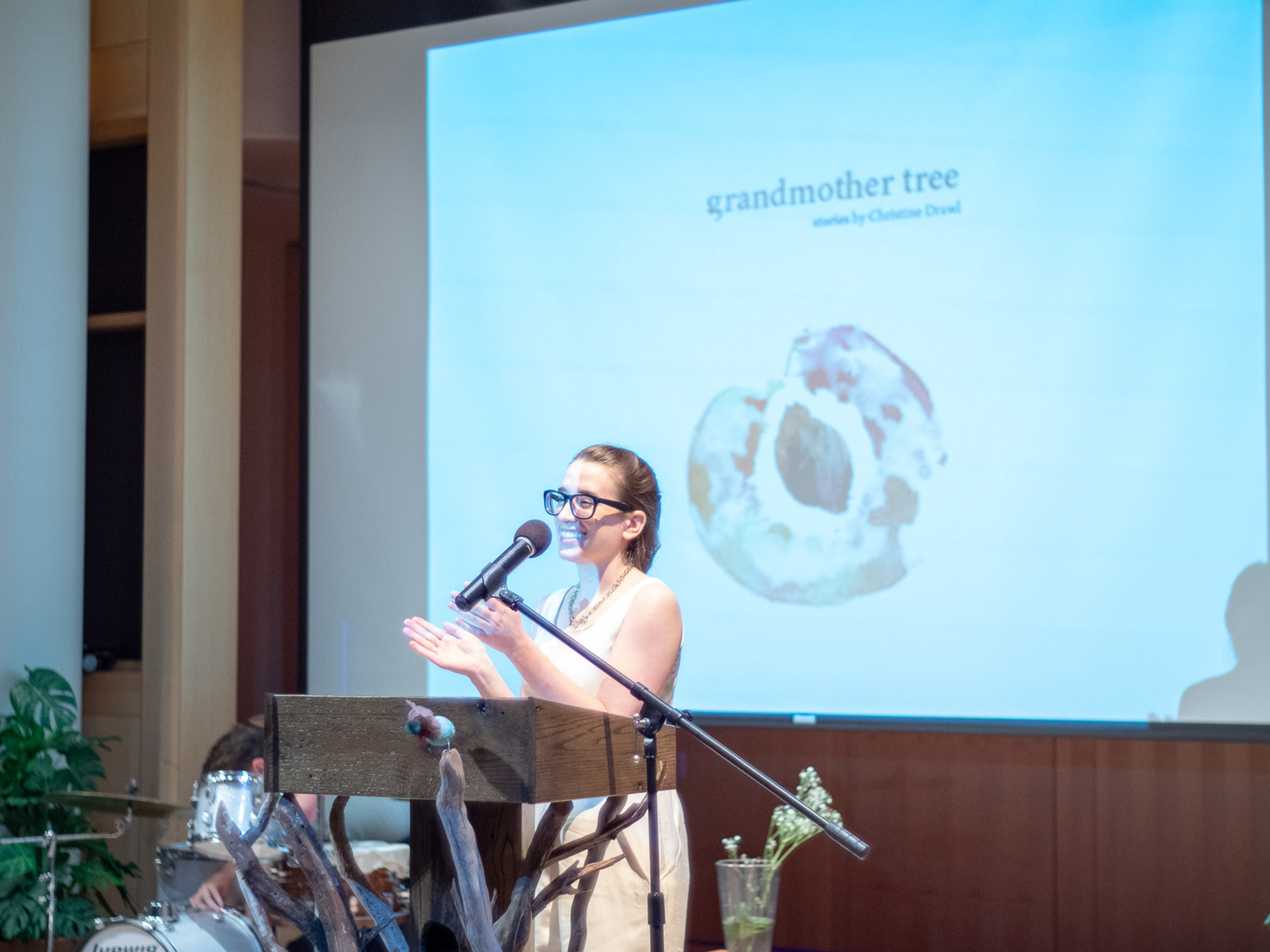 A student reads from her book at the podium