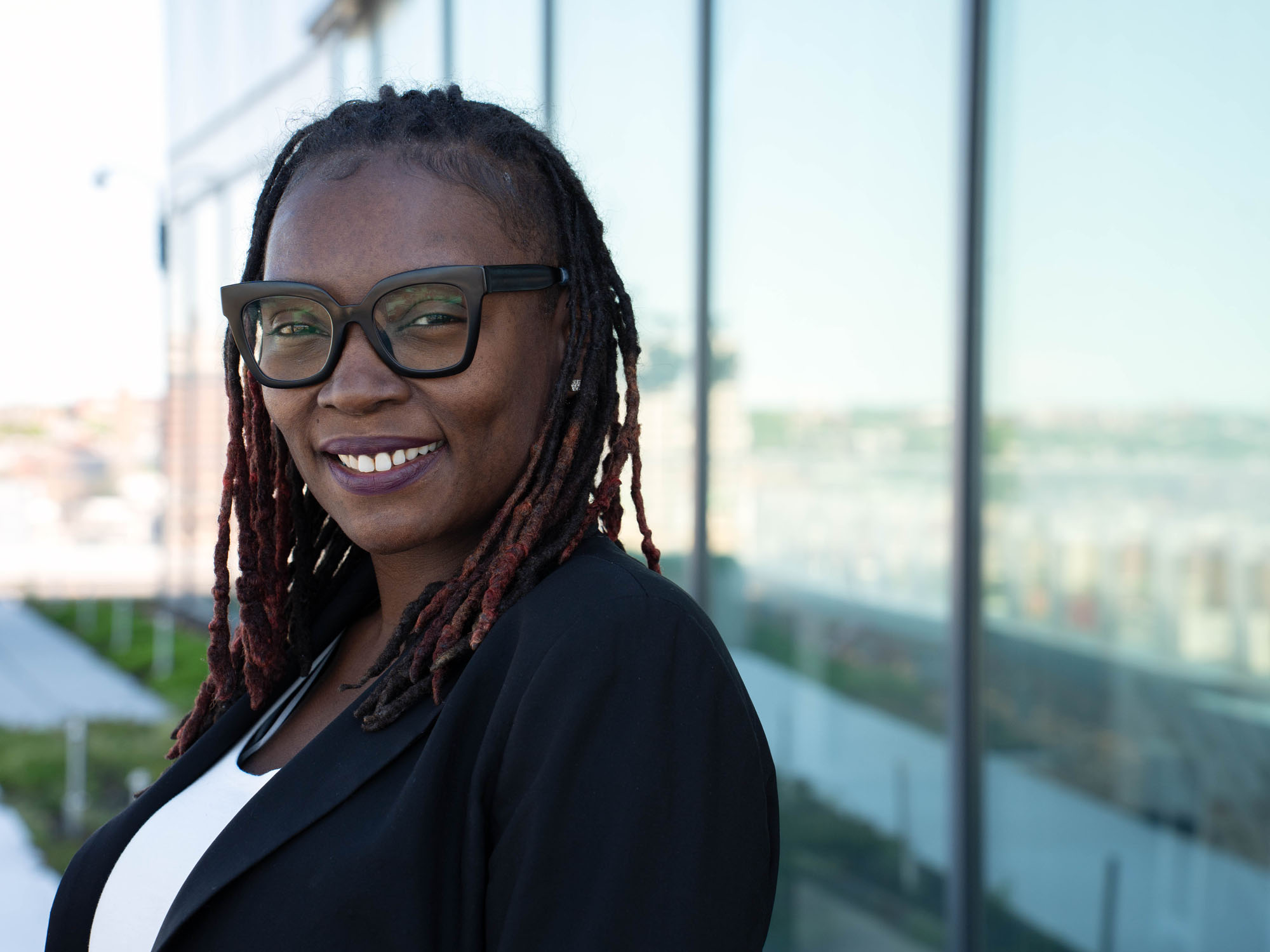 Barbara Wilkins smiles at the camera while posing at the law center.