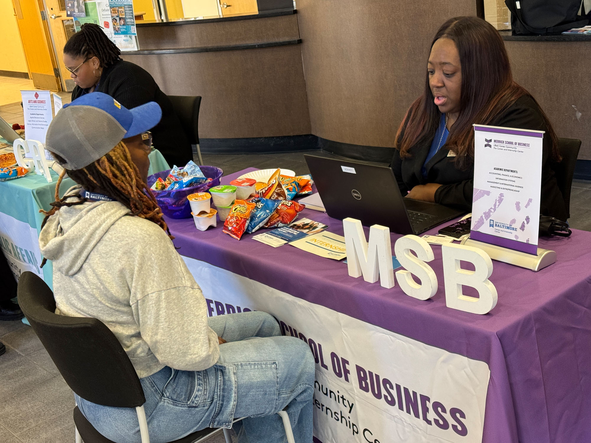 La-Toya Gomez, career coach, advises a student during a career center event.