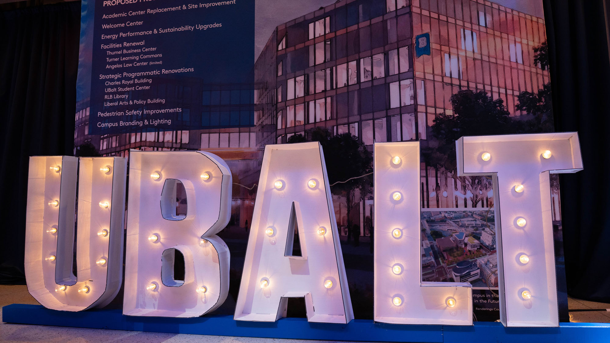 A lit-up sign reading UBALT shines as one of several exhibits on display during the Grand Celebration.