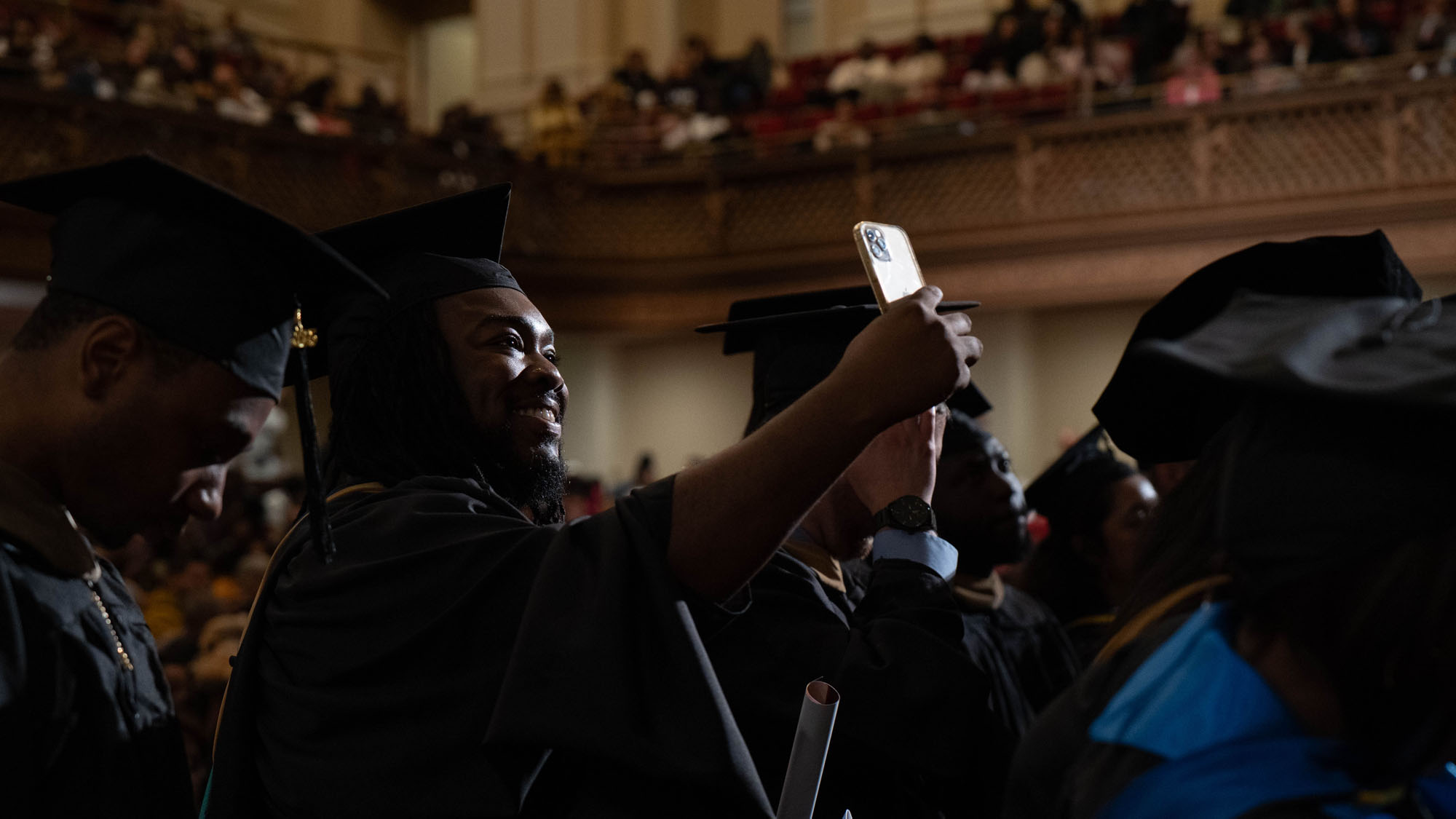 A graduate takes a selfie.