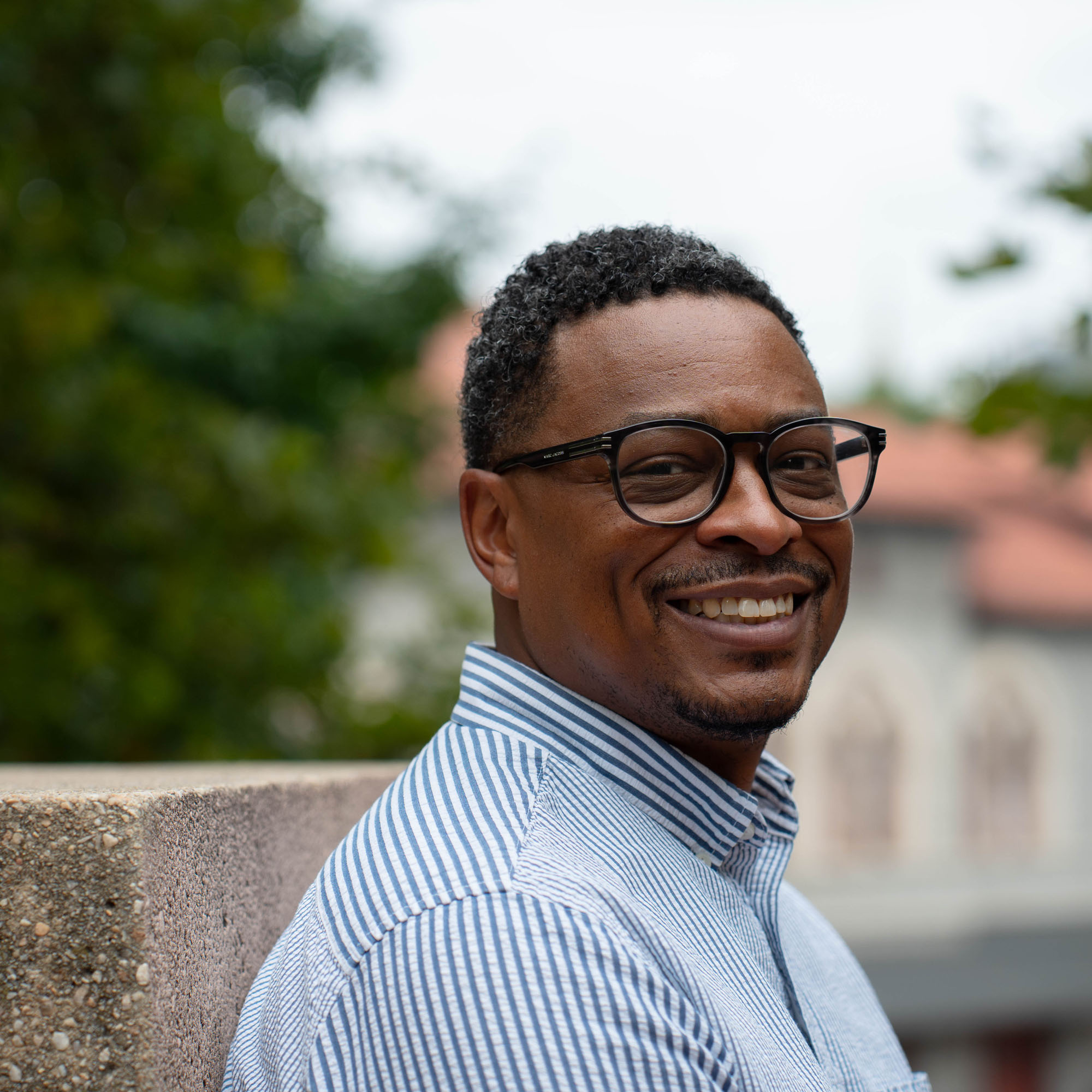 Carey, a UBalt employee, smiles during an interview in a Baltimore park.