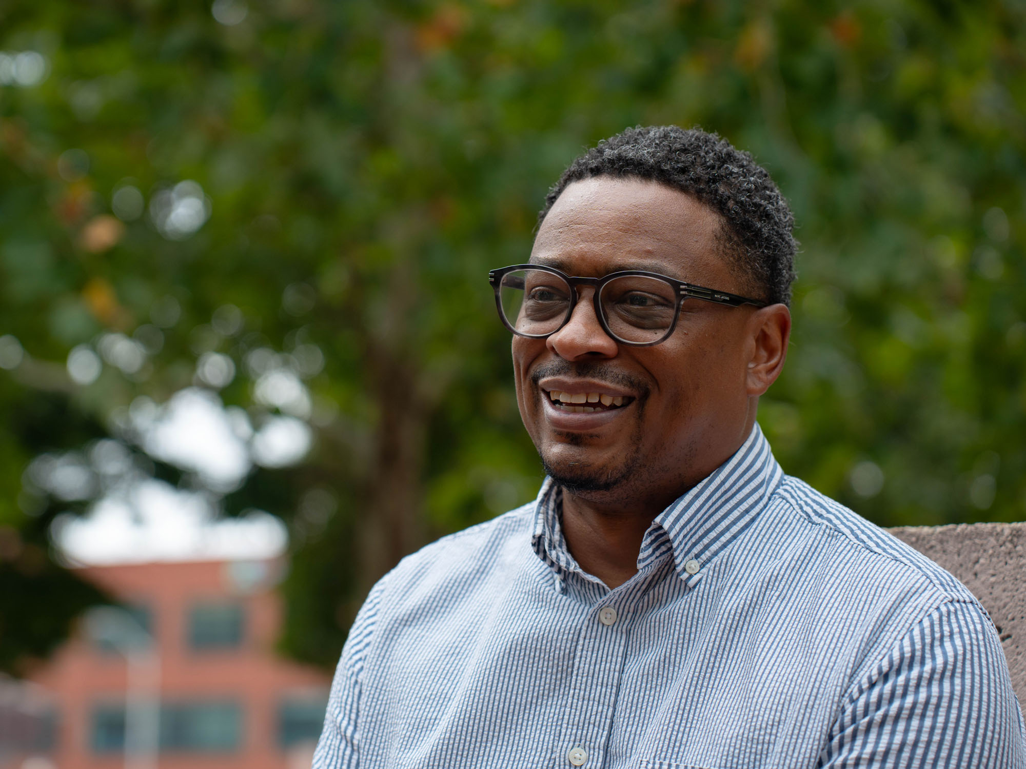 Carey, a staff member from UBalt, smiles during an interview while looking on. 