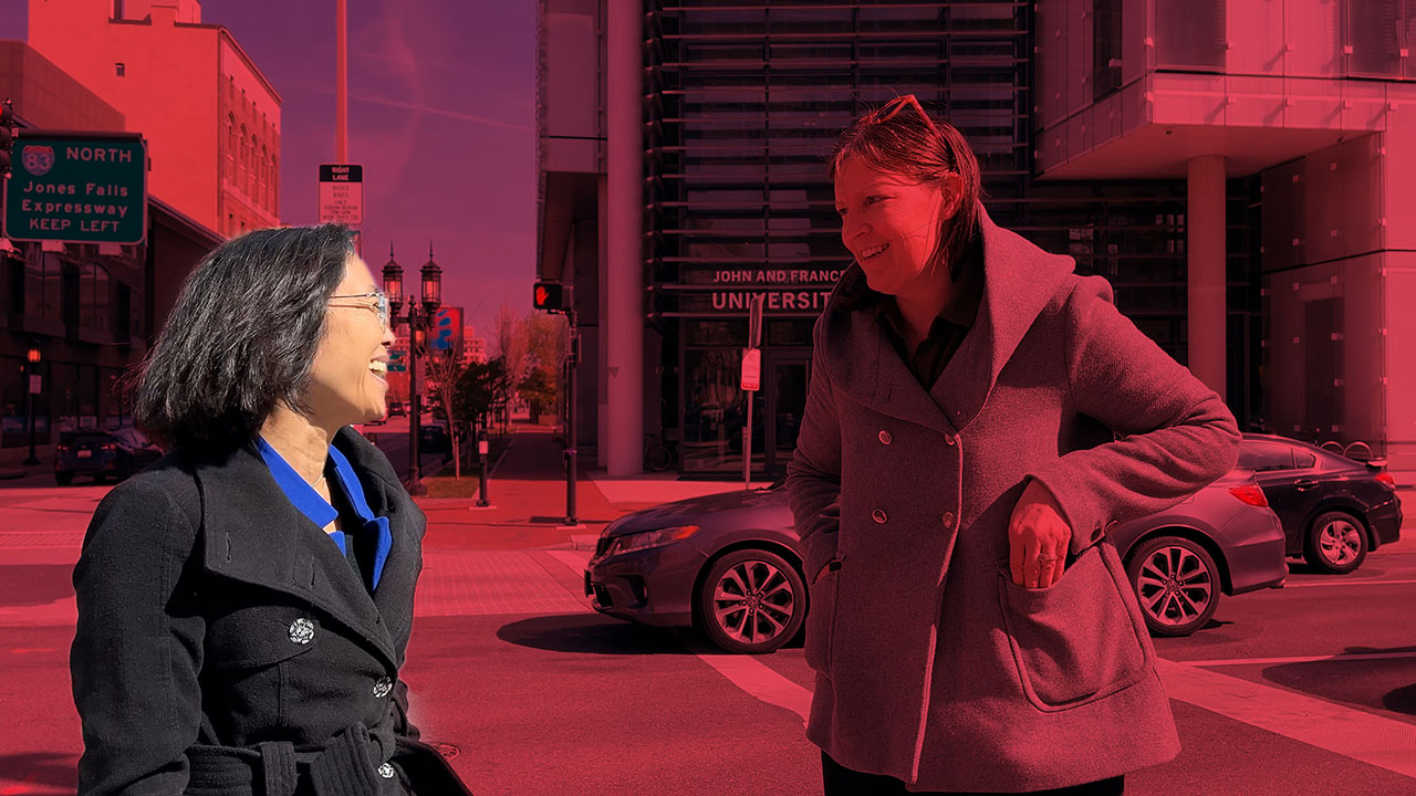 Jaime Lee, a professor, smiles while crossing a street. She stands out in the graphic illustration, colorized in red to put focus on Jaime.