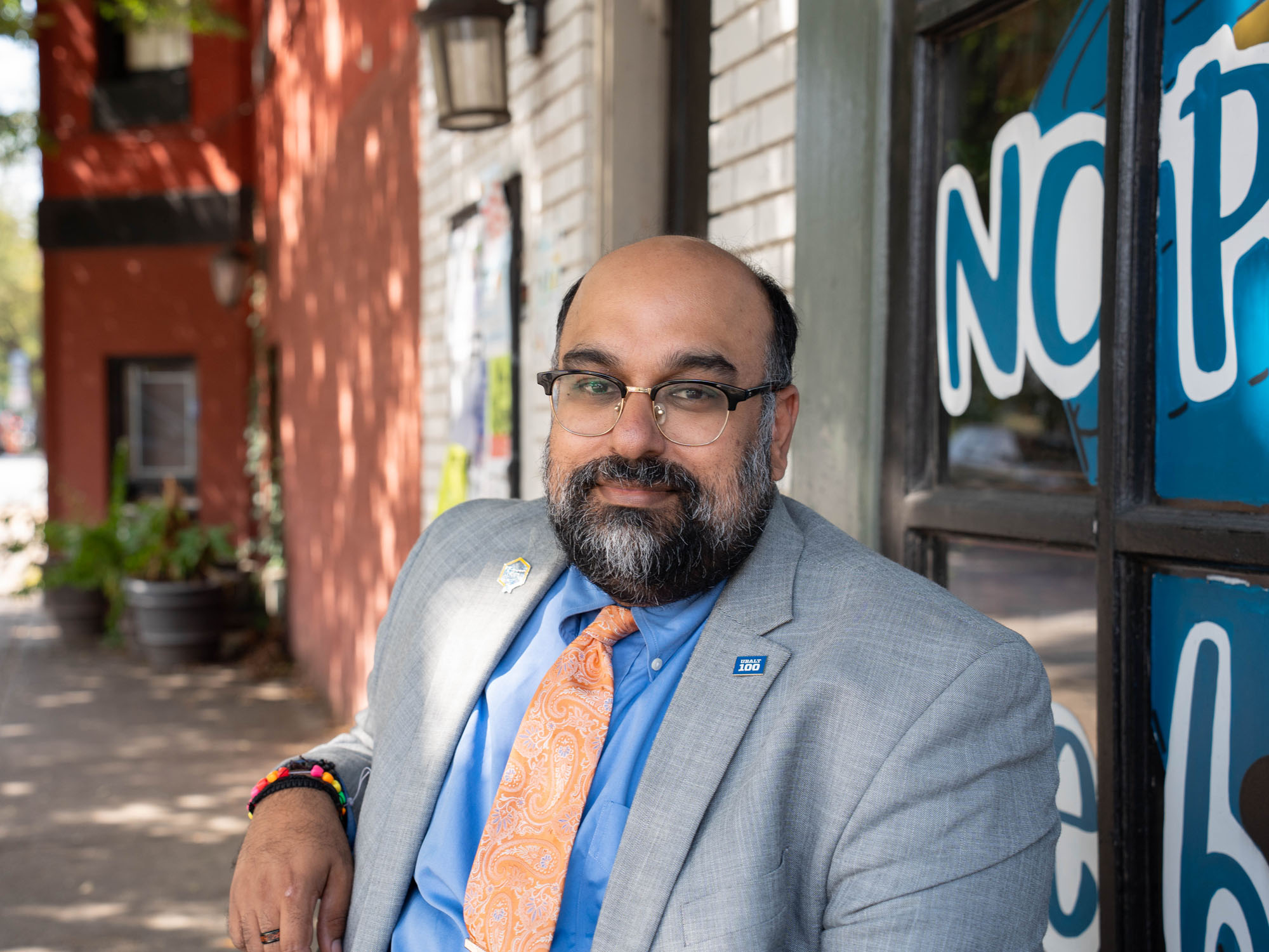 Pavan Purswani, a staff member at UBalt, sits outside a cafe in Baltimore.