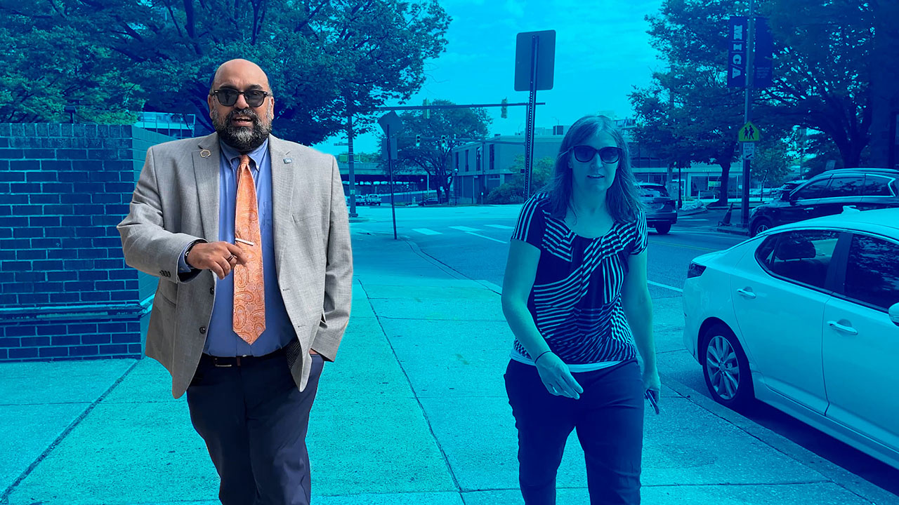 Standing out in a blue-washed photo, Pavan Purswani walks toward the camera.