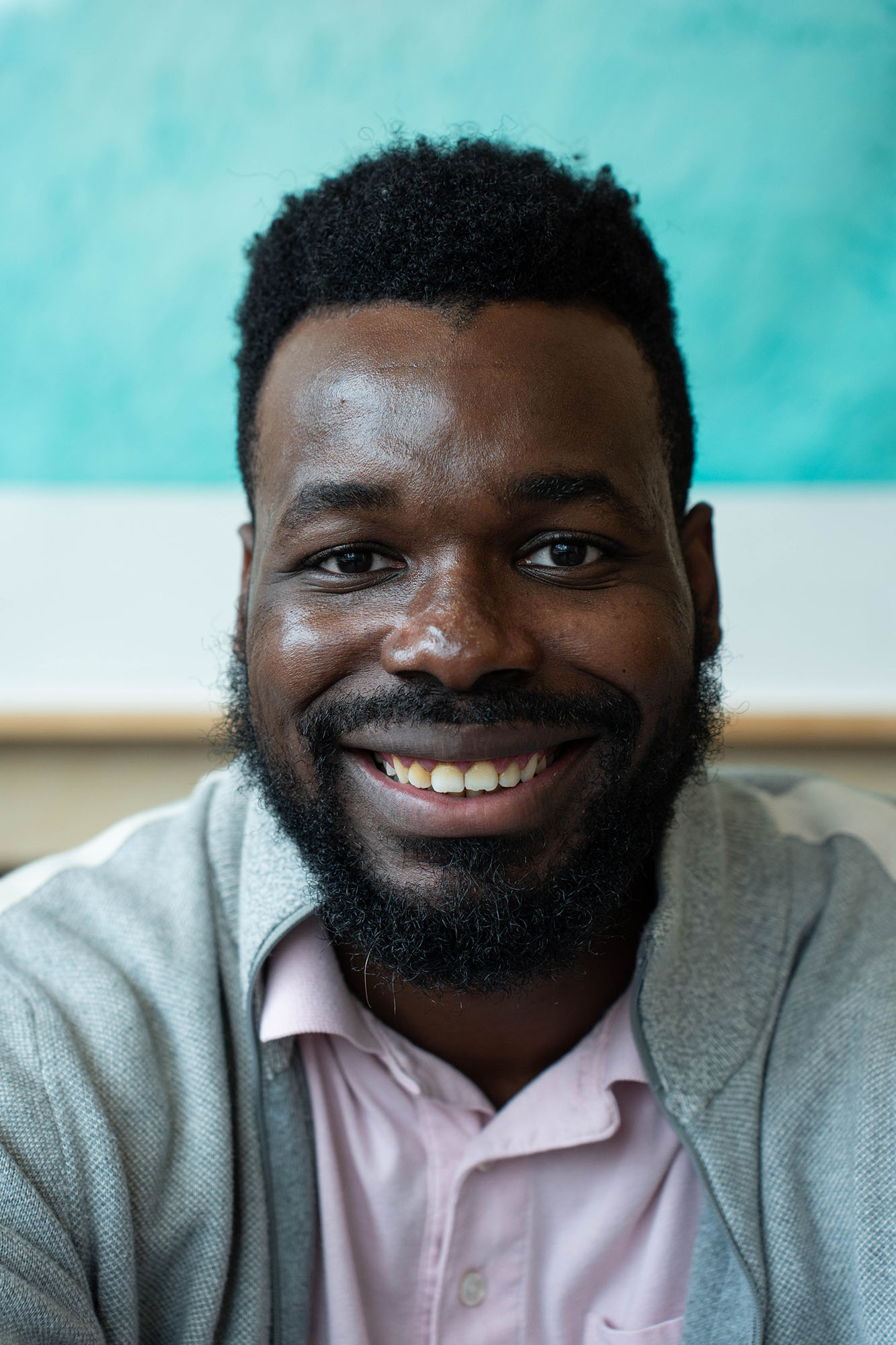 A close up headshot of a student smiling at the camera