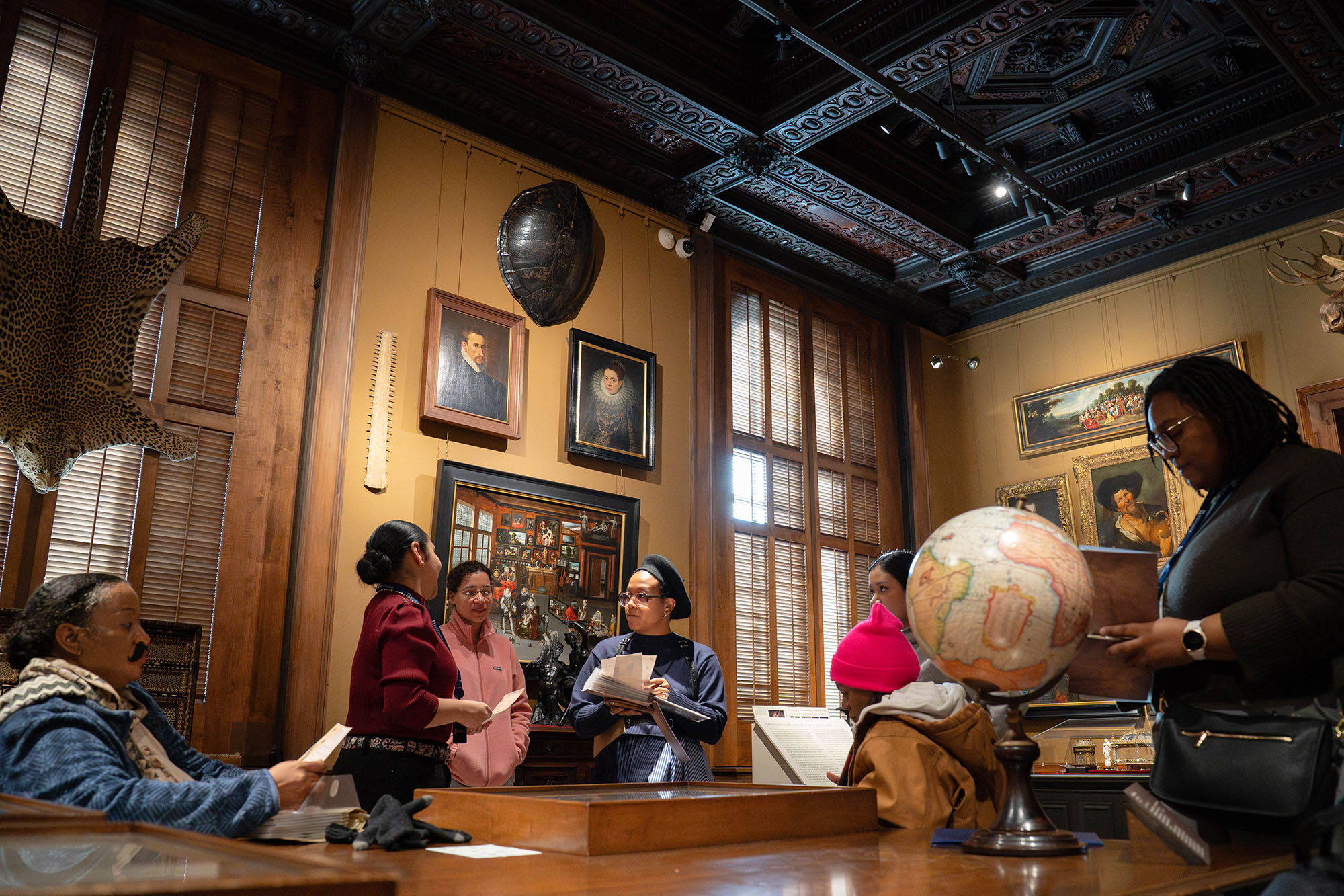 Students explore the Chamber of Wonders in the Walters Art Museum.