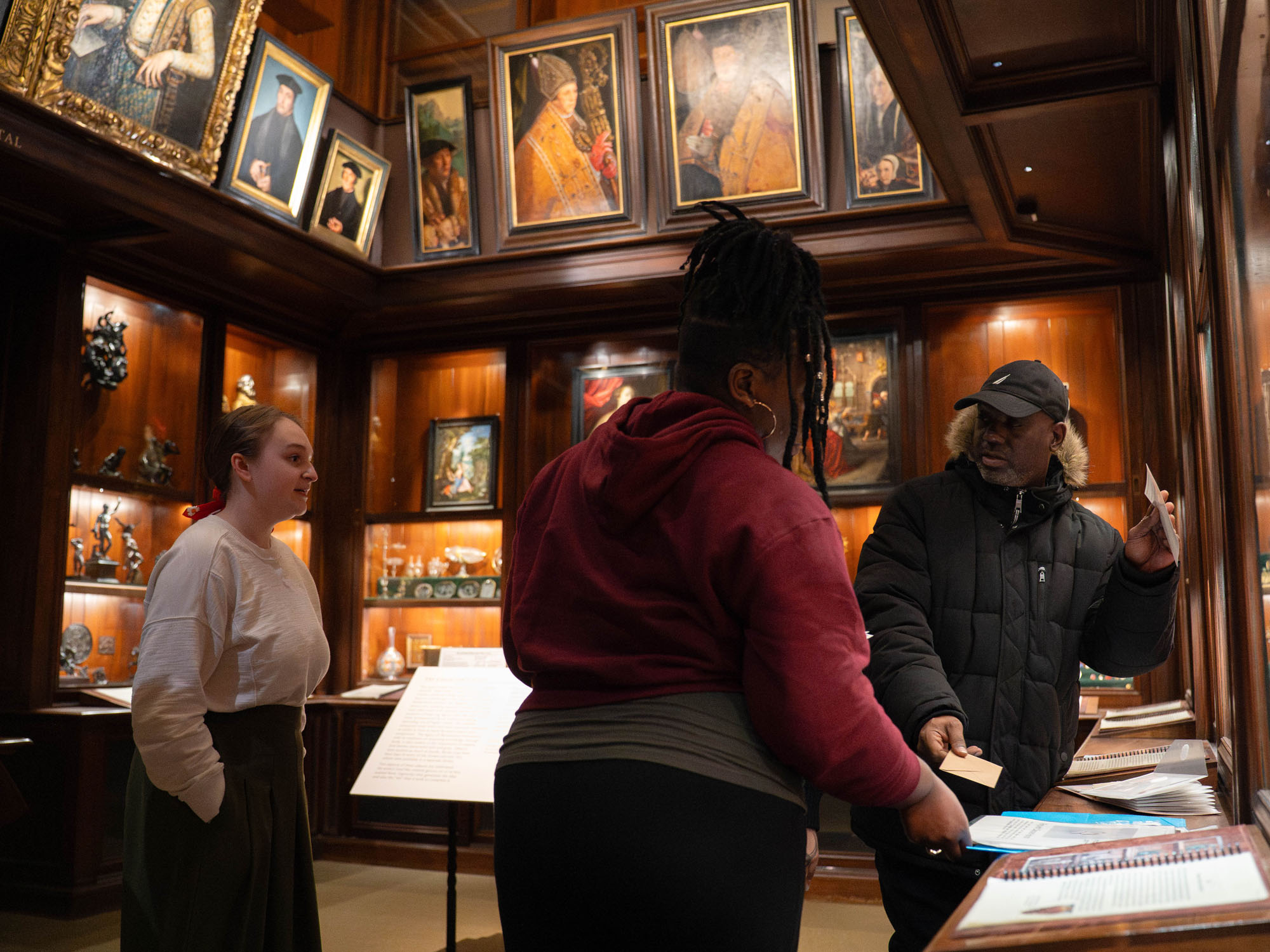 Students consider the aspects of an escape room they built while standing inside an exhibit room at the Walters Art Museum.