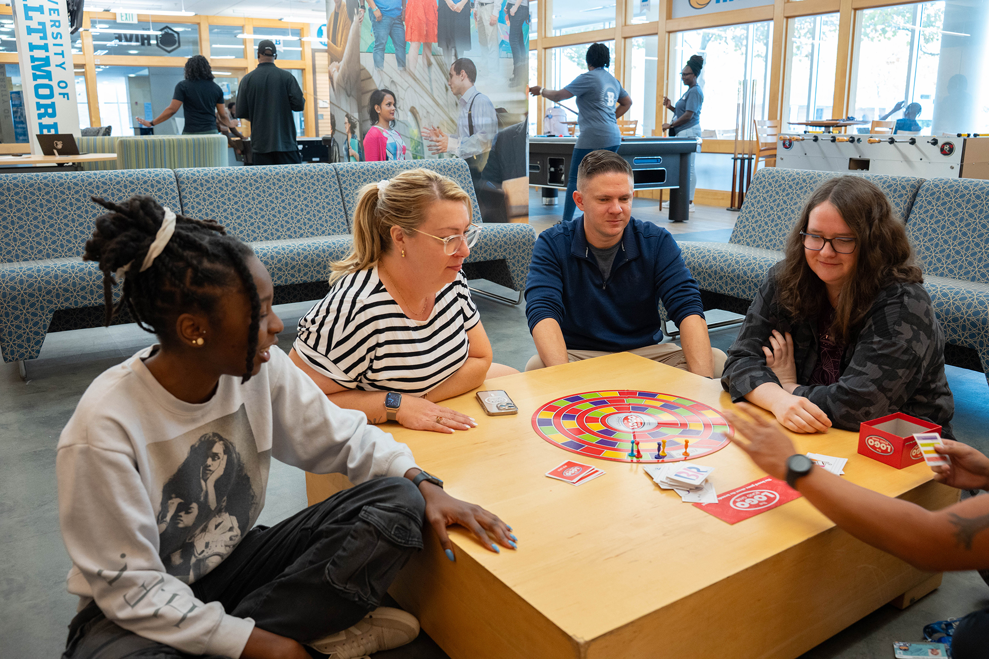 A group sits around a table to play a board game