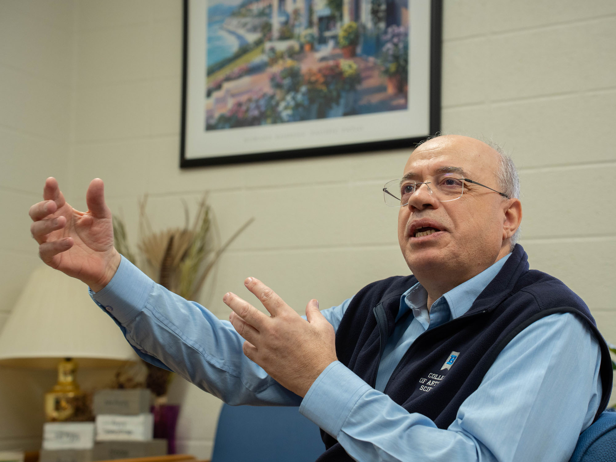 Haitham Alkhateeb gestures with his hands while sharing a story during an interview inside his office suite.