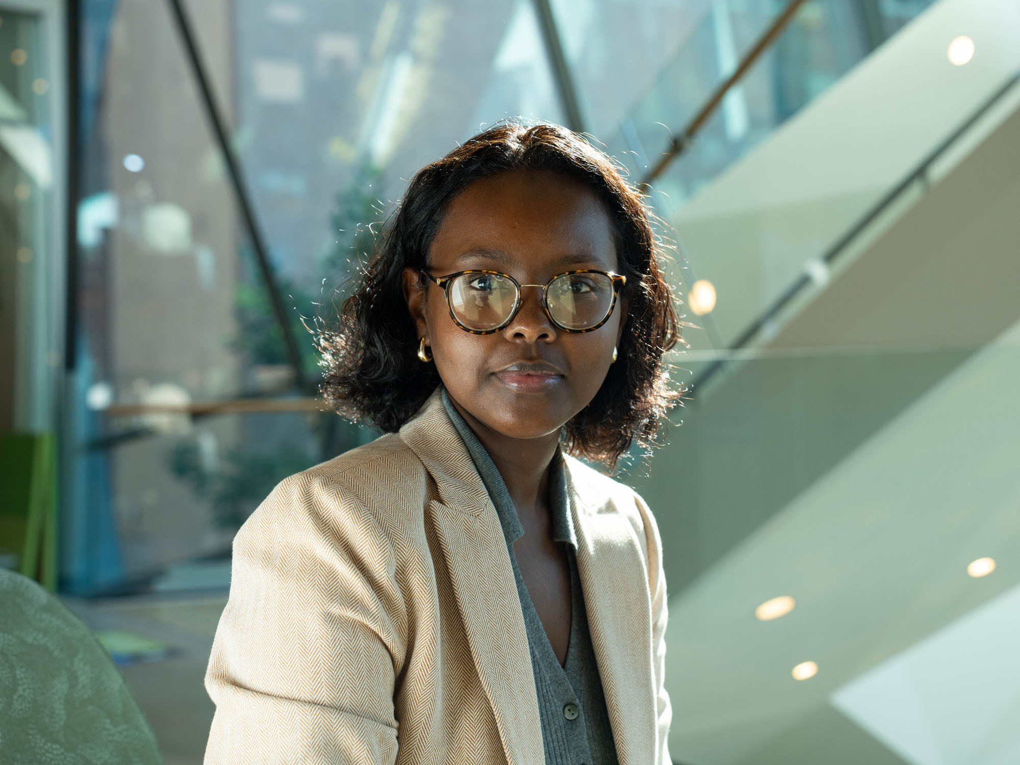Idil Omar smiles at the camera while posing in the UBalt library.