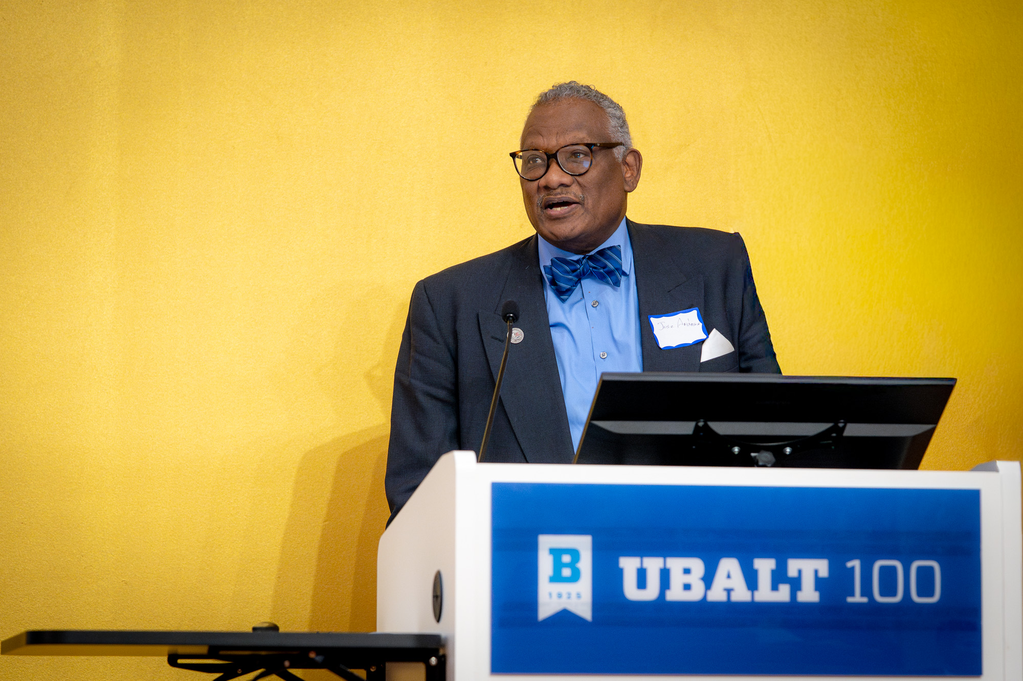 A person speaks at a podium during a University of Baltimore School of Law event.