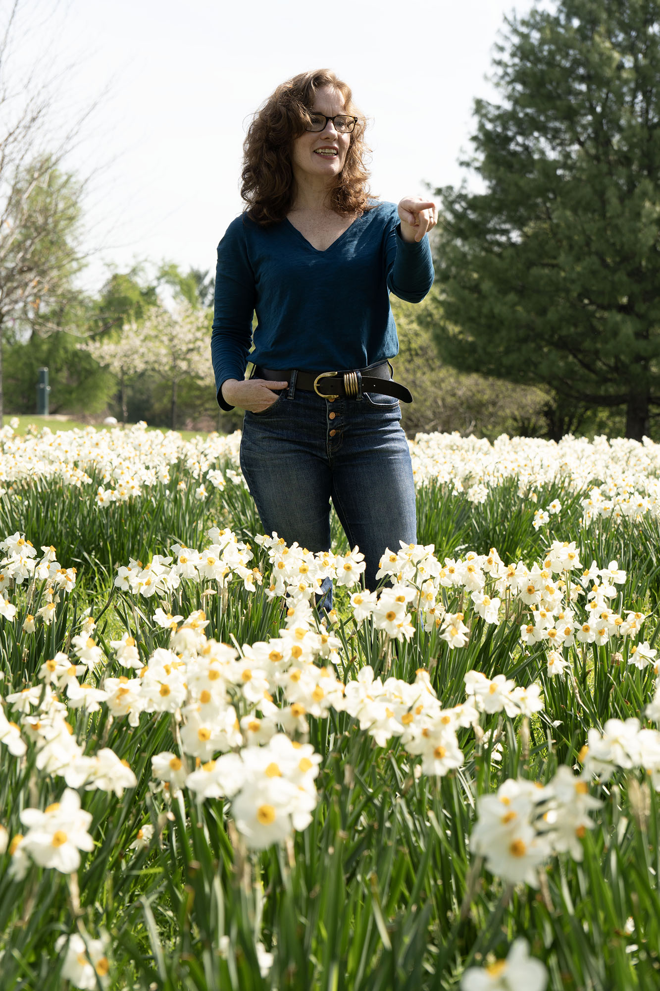 Jane Delury stands in a field of daffodils.