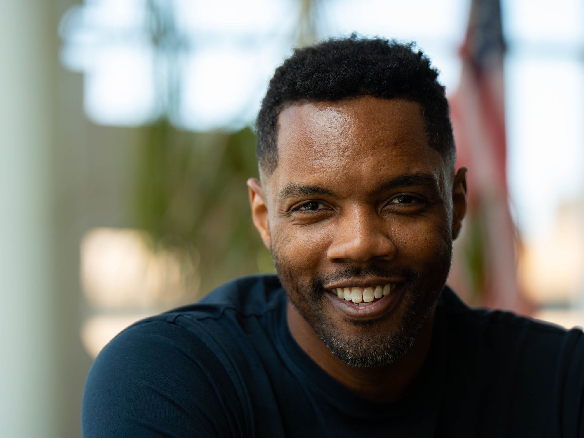 Javon, a law student and veteran, smiles during a portrait shoot on campus. 