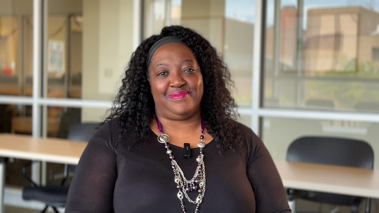 La-Toya Gomez smiles at the camera during an interview