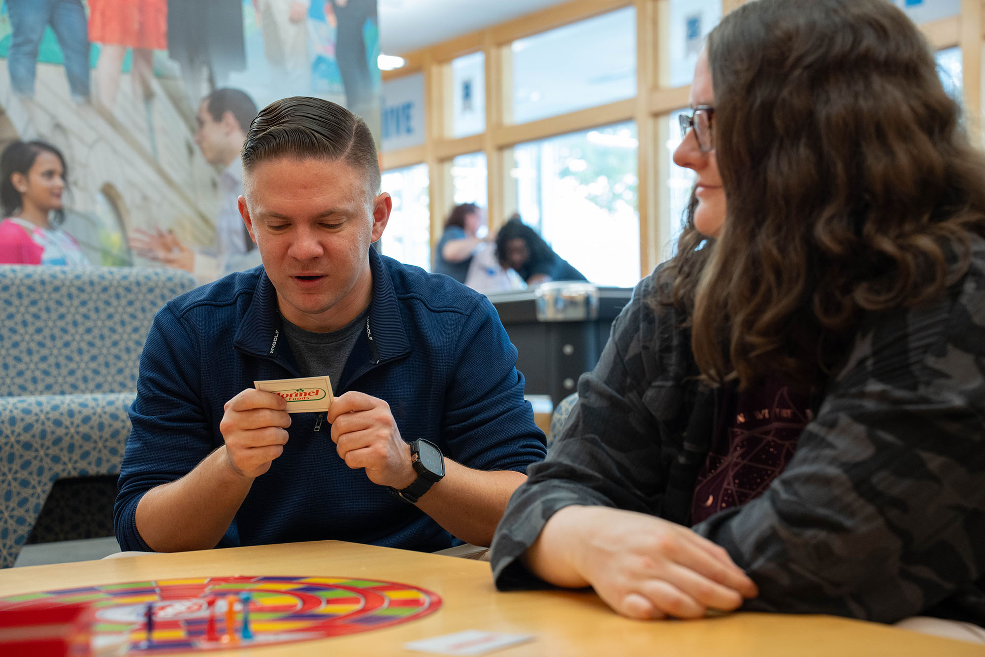 Michael Claxton plays a board game with friends on the UBalt campus.
