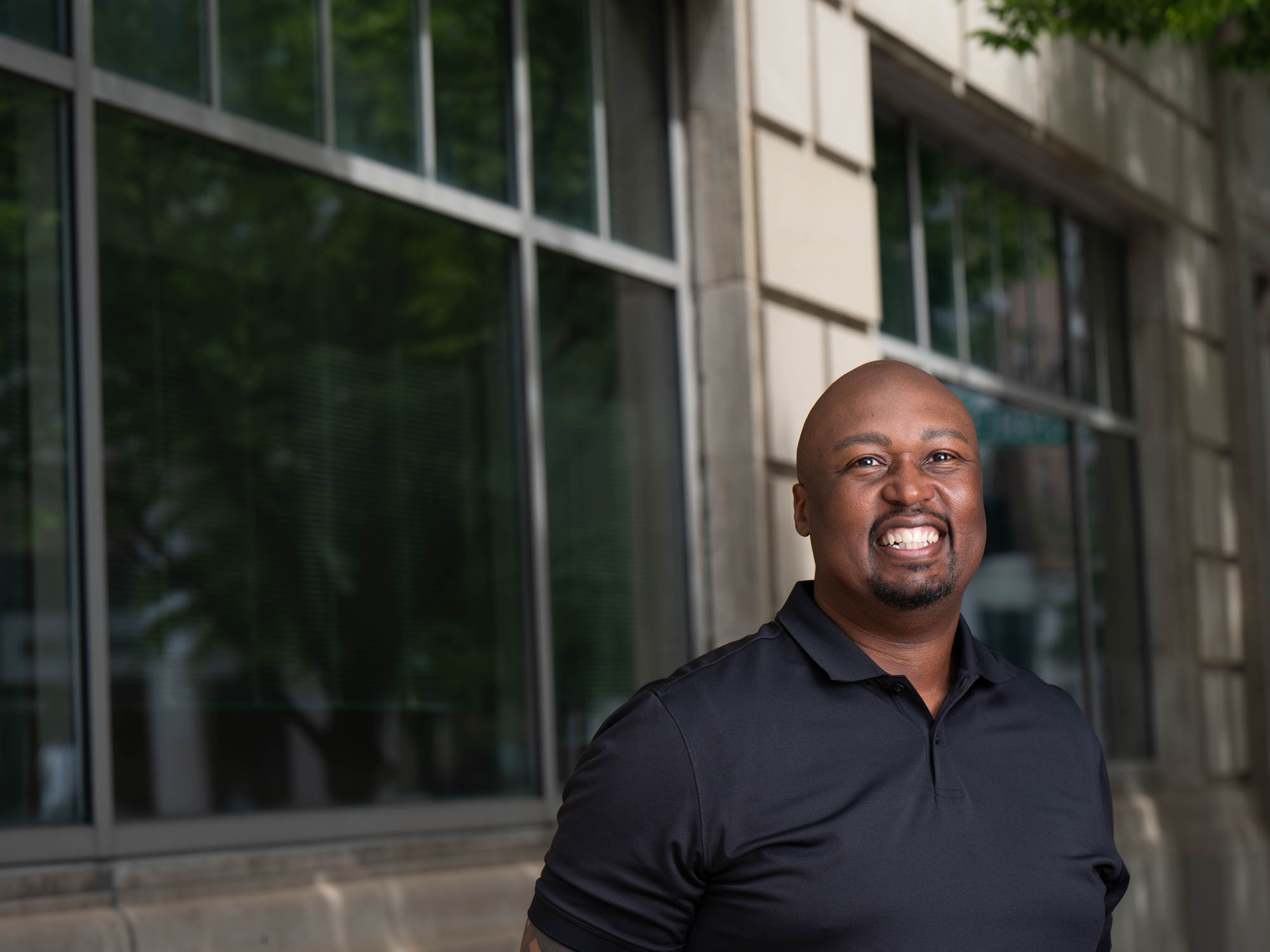 Michael Jones smiles while posing on campus