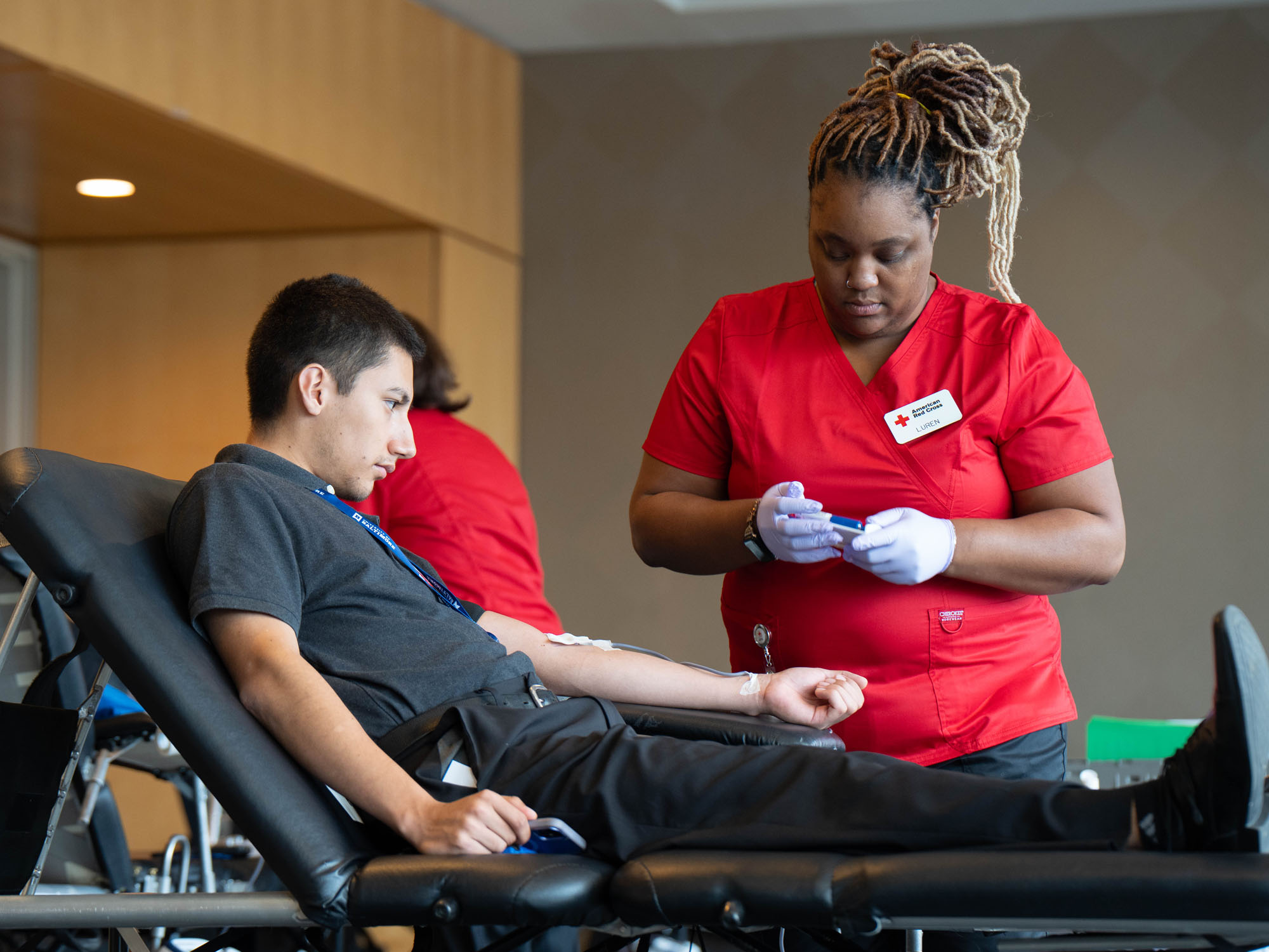 A student prepares to give blood during a Red Cross blood drive.