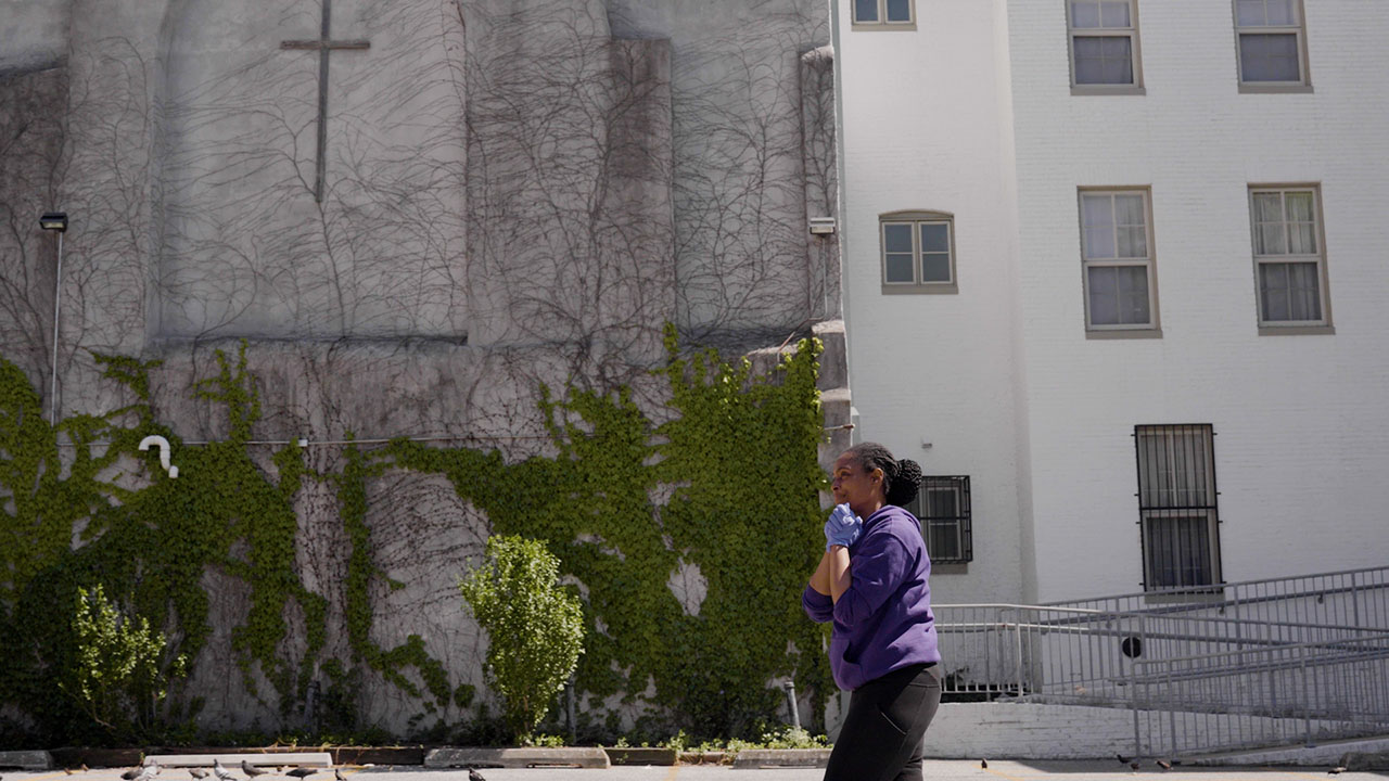 A student is seen walking across the scene in front of a church in Baltimore. 
