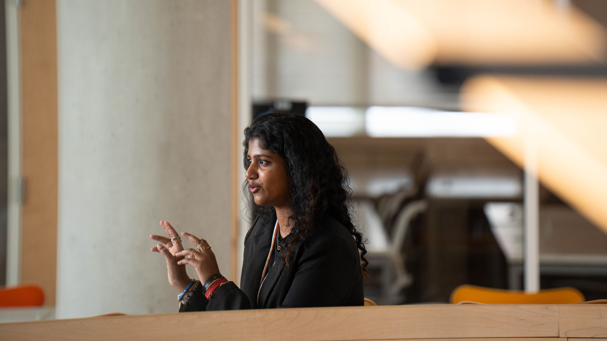 A student talks inside the law school building while looking off camera