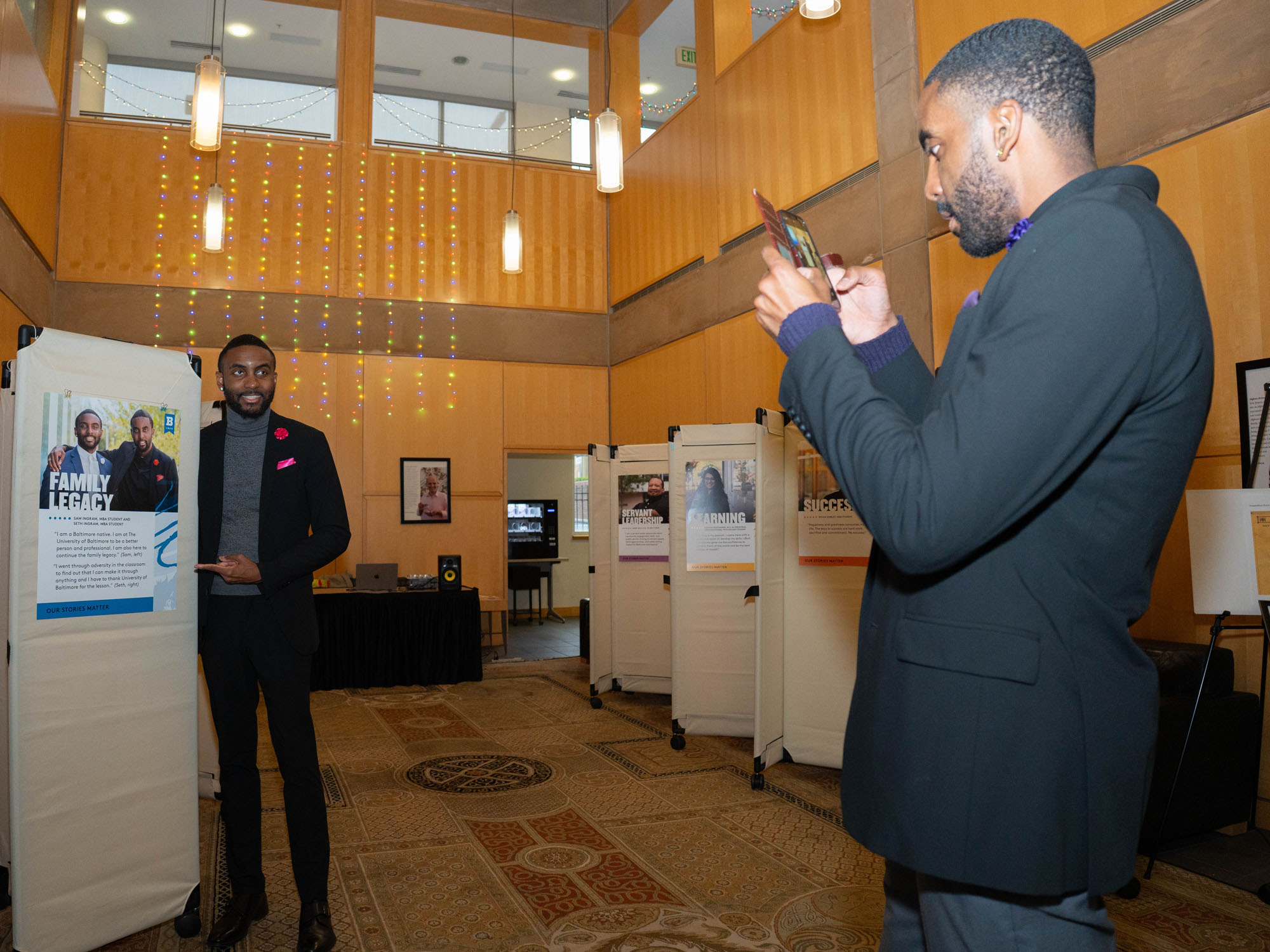 Sam and Seth Ingram observe the poster featuring the two of them.