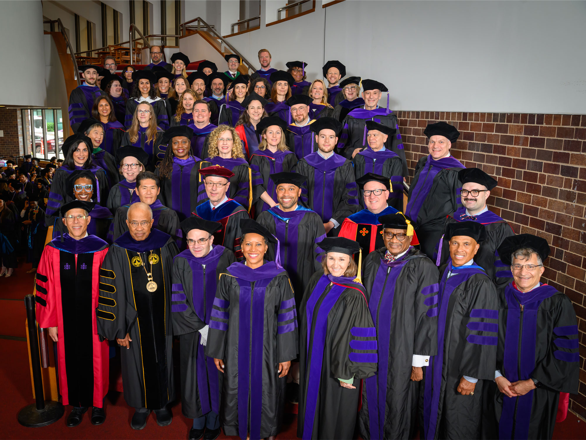 **Alt text:**   University of Baltimore School of Law faculty and administrators pose together in academic regalia at commencement.