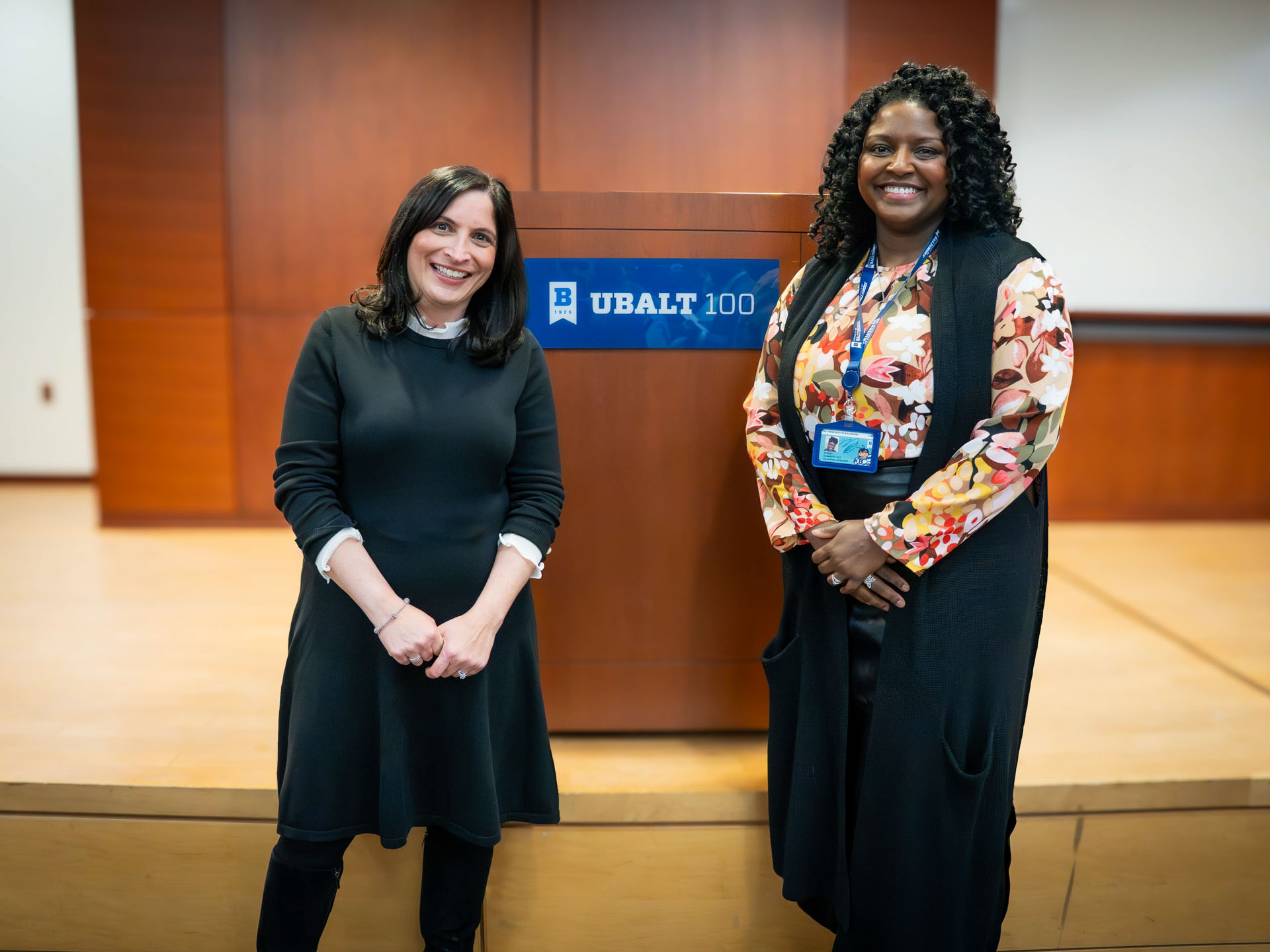 Two individuals stand in front of a podium during a University of Baltimore School of Law recognition ceremony.