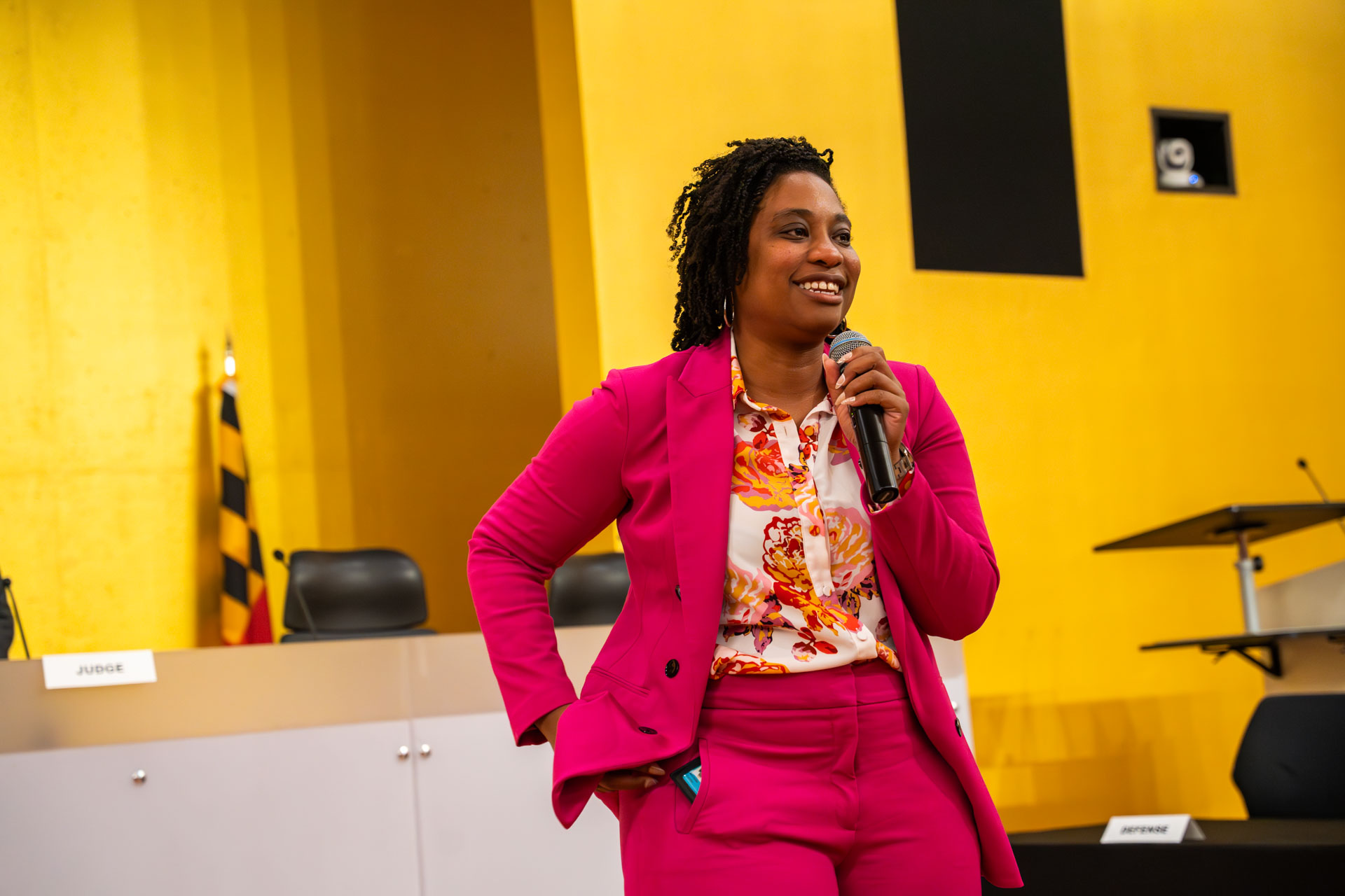 A person speaks into a microphone during a University of Baltimore School of Law event.