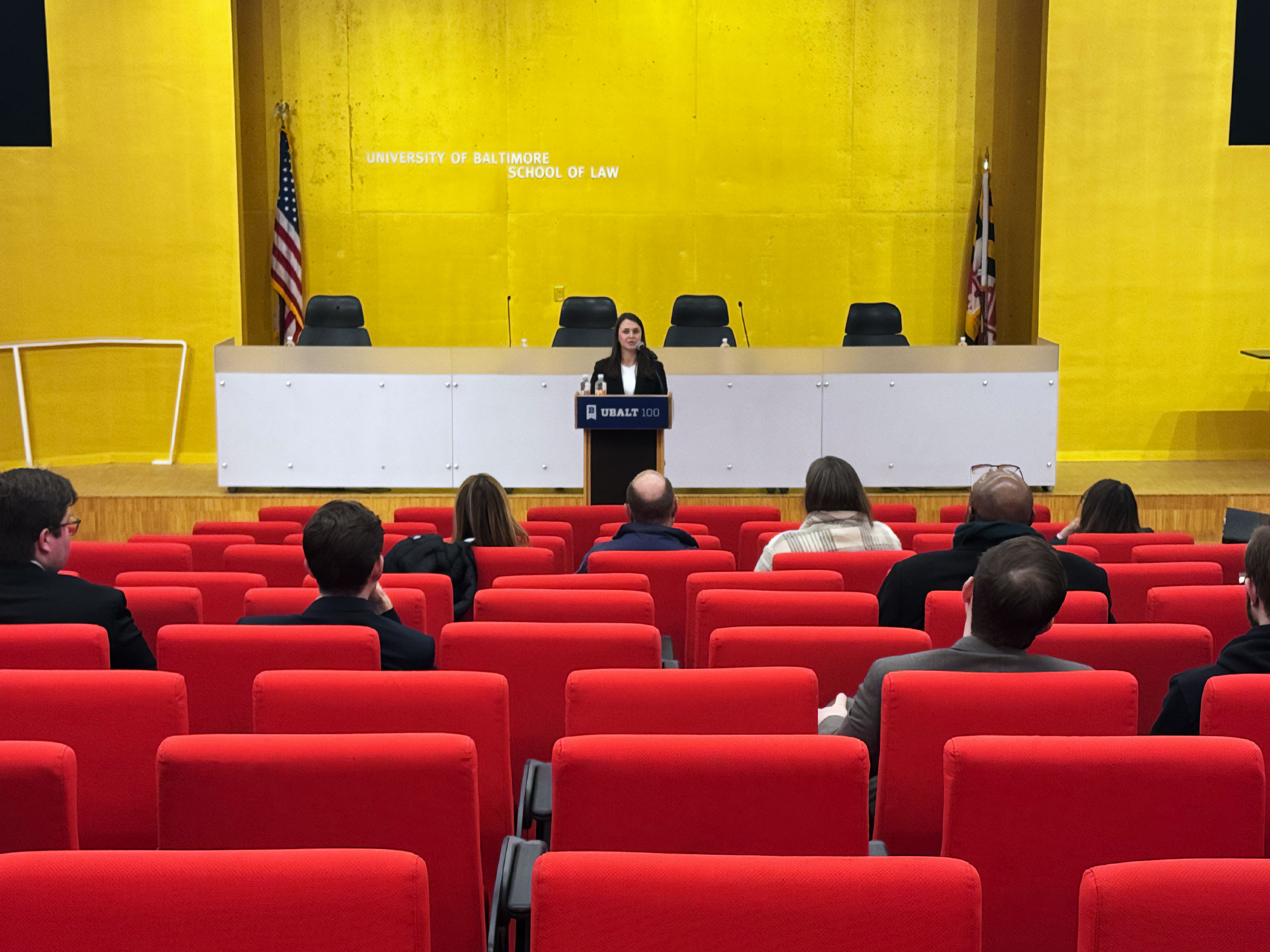 Dean LaVonda Reed and Judge Laura Ripken stand with a colleague in a modern university building during a formal event.