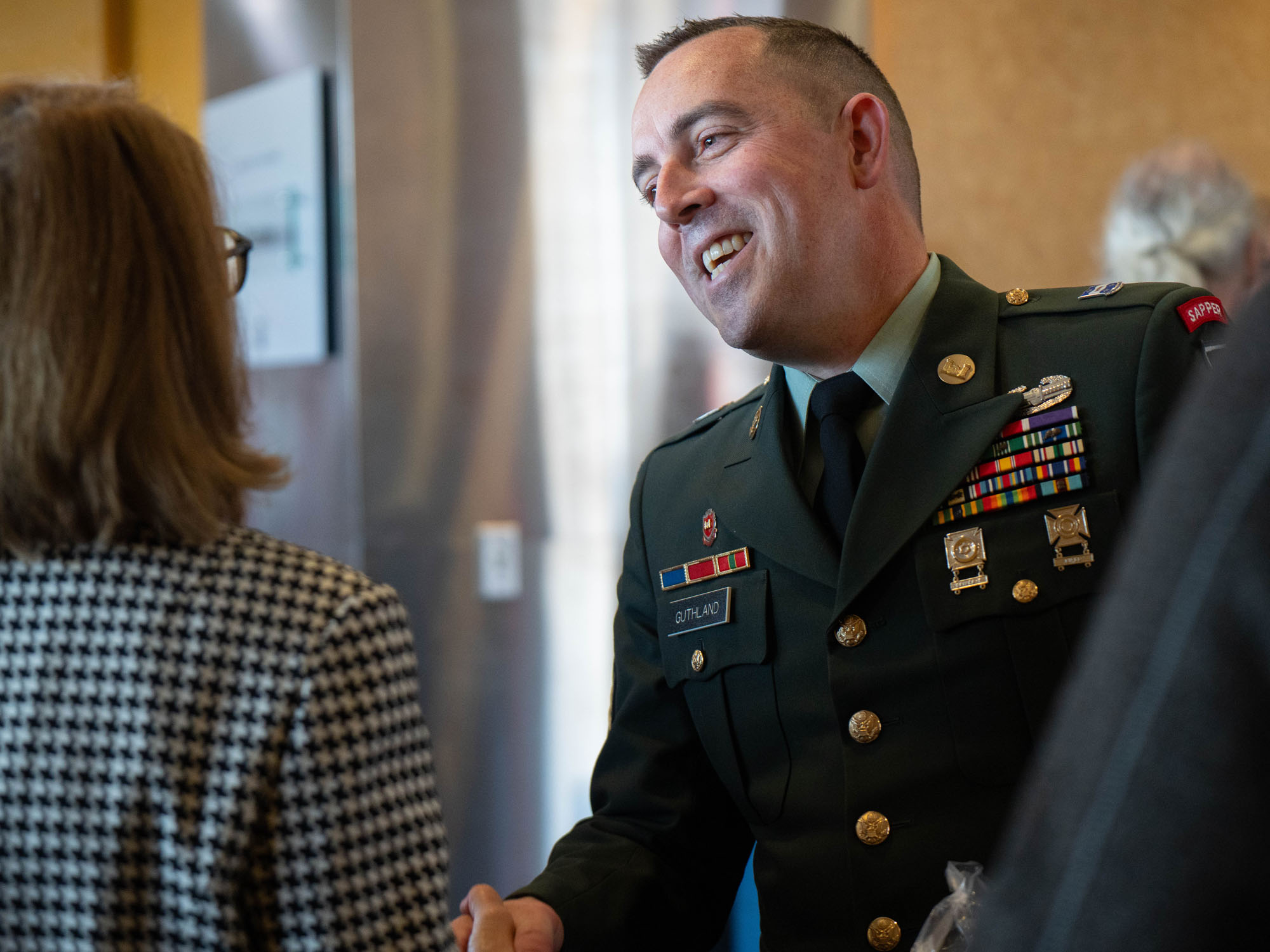 Josiah Guthland shakes hands with a guest of the Veterans Day ceremony.