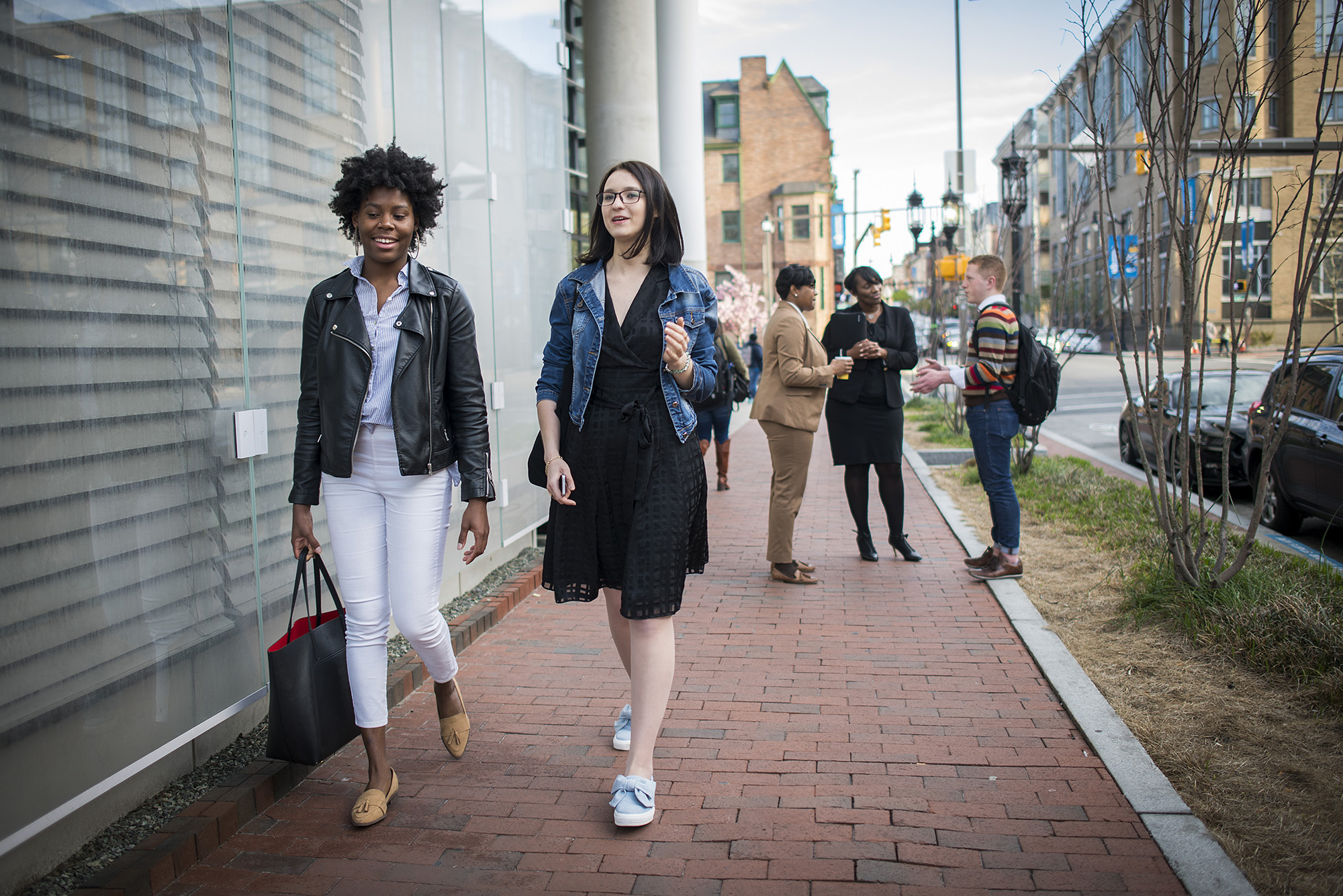 Students walking along the Charles Street side of the Angelos Law Center