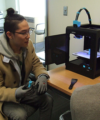 Student entrepreneur works with 3D printer 