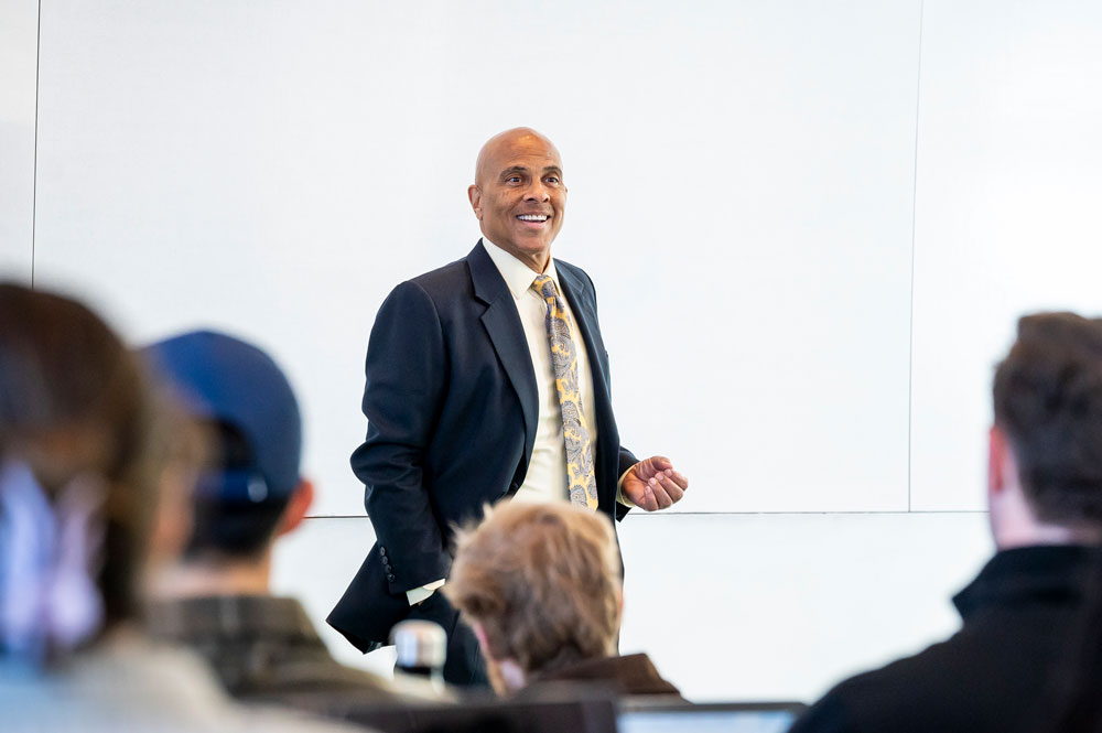 A professor speaks to students in a law school classroom during a lecture.