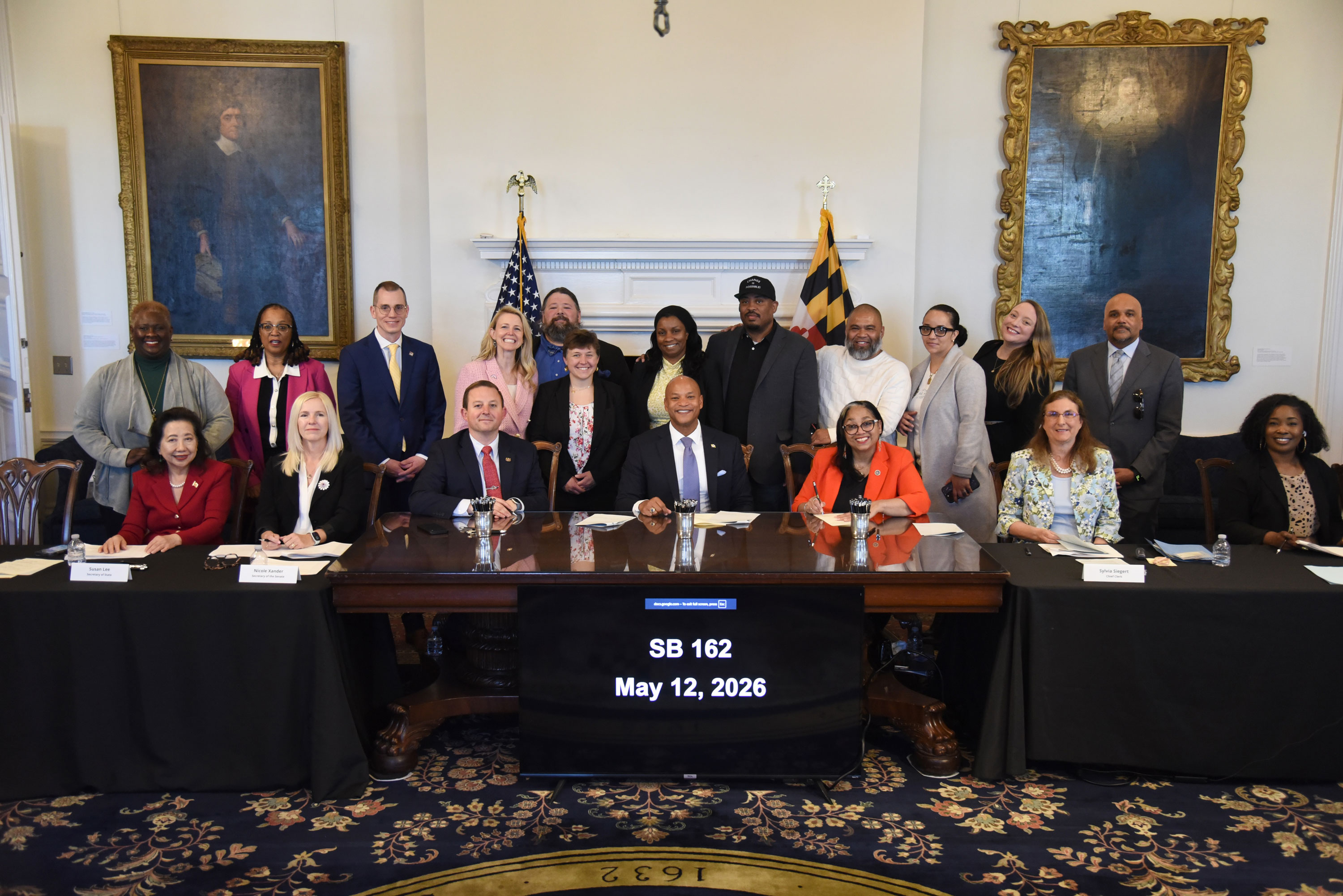 Group of officials and community members pose together during the signing of Maryland Senate Bill 162 on May 12, 2026.