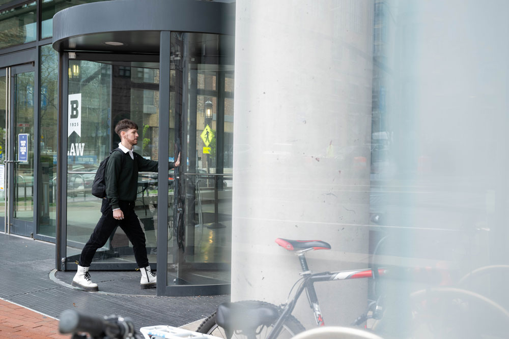 A student enters the University of Baltimore School of Law through the revolving doors of the John and Frances Angelos Law Center.