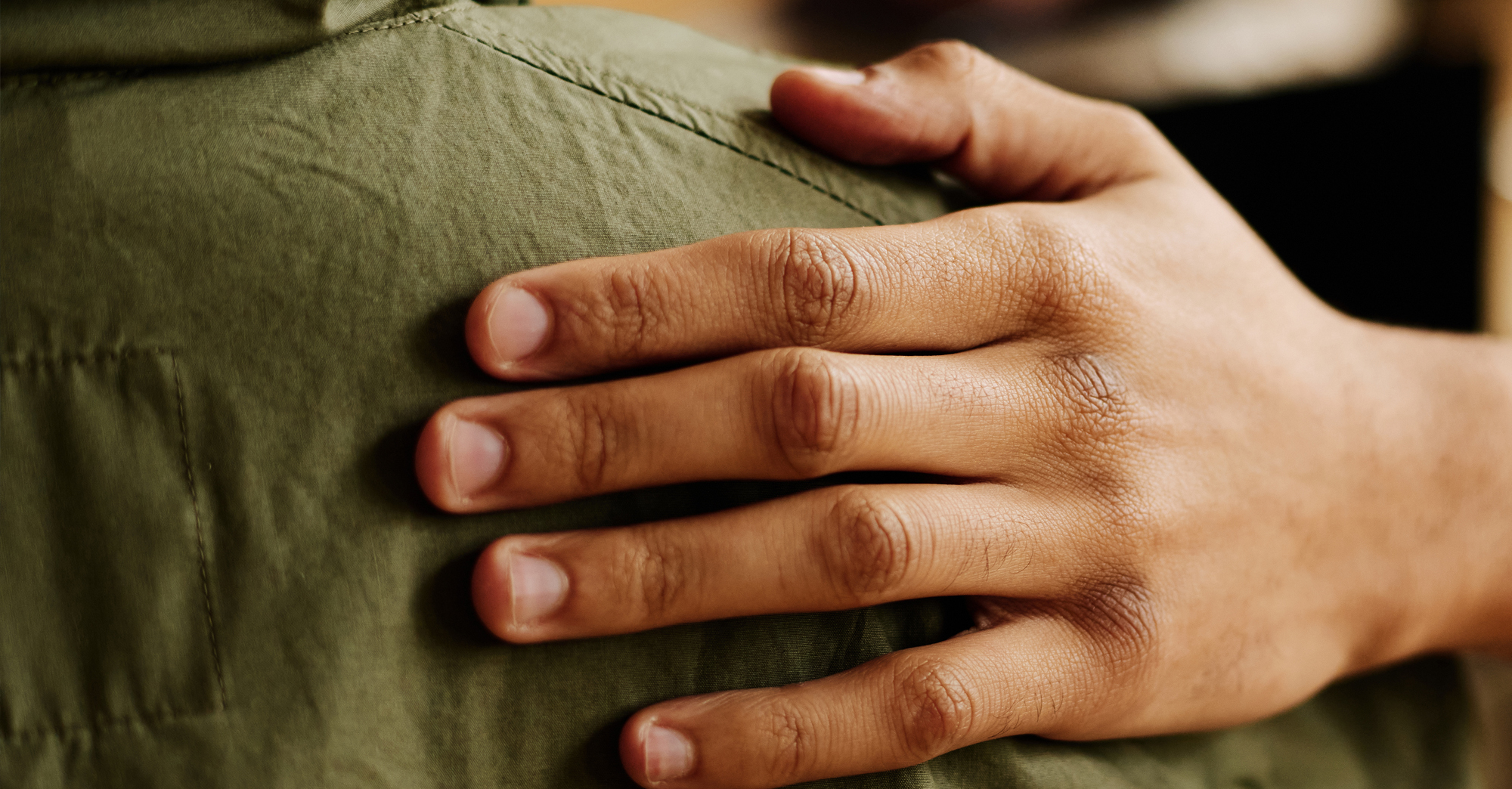 hand on the shoulder of person in need