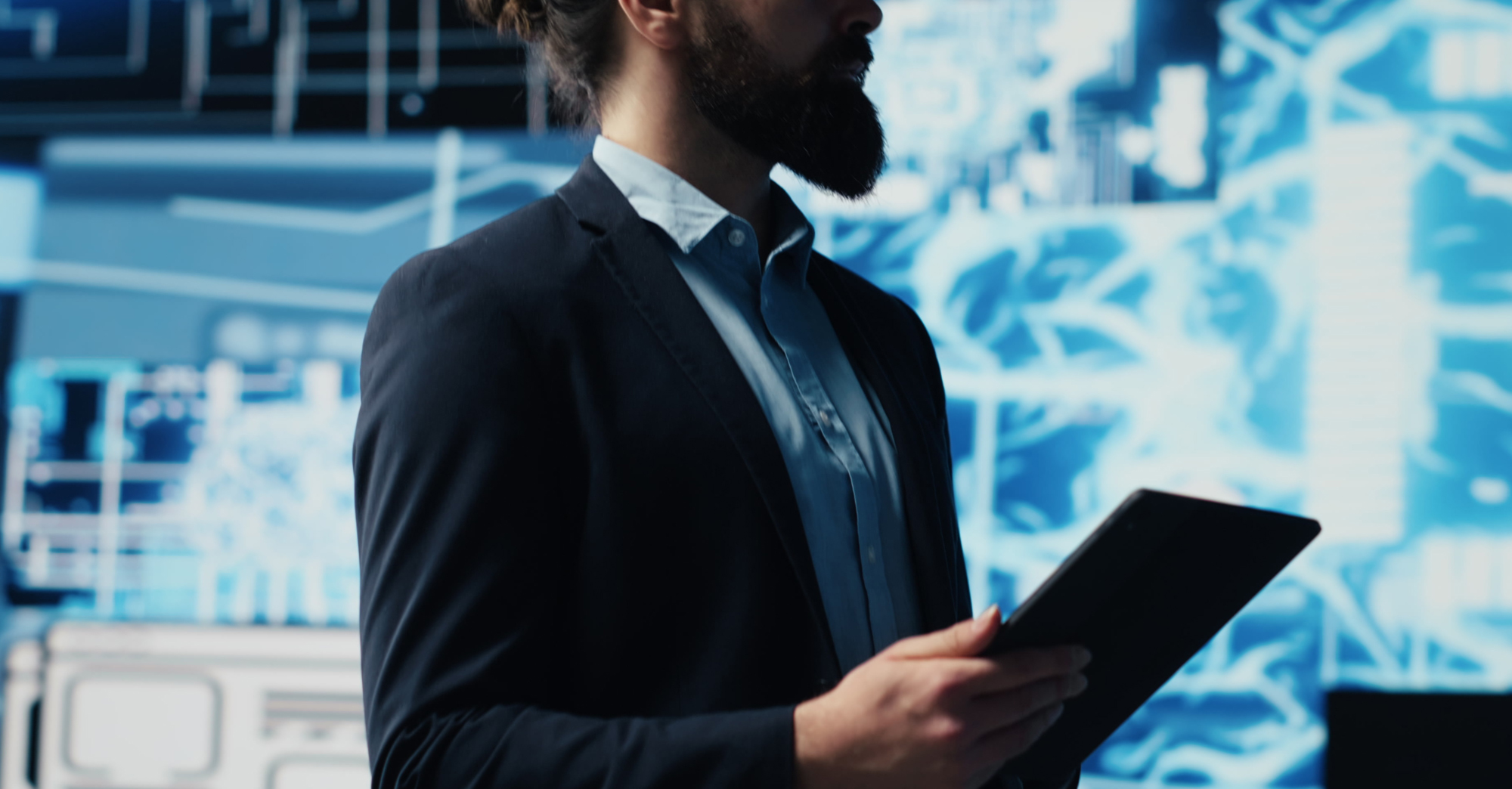 hero image of a man holding a tablet with technology images