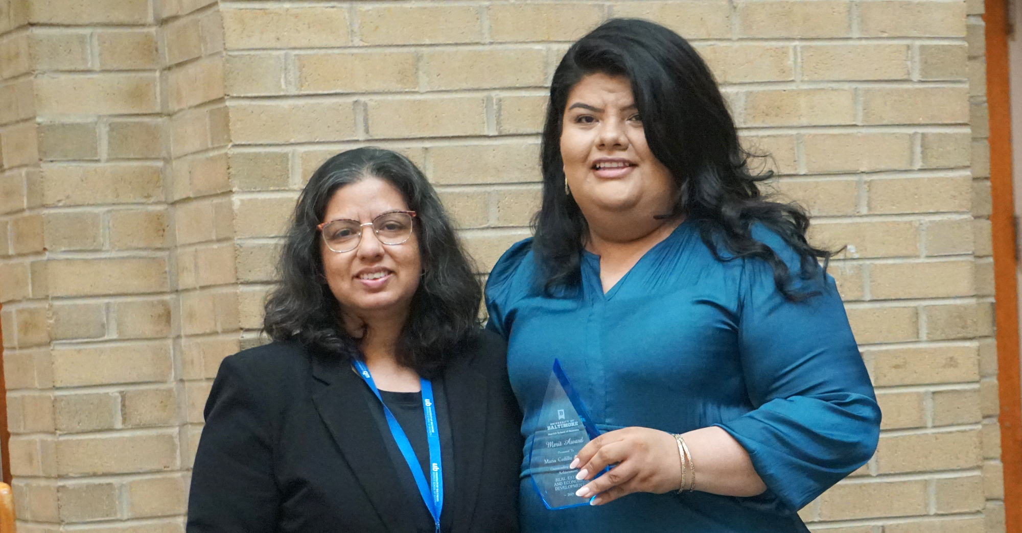 Dr. Nafessa Yunus presents the Real Estate Merit Award to Maria Cedillo Arevalo