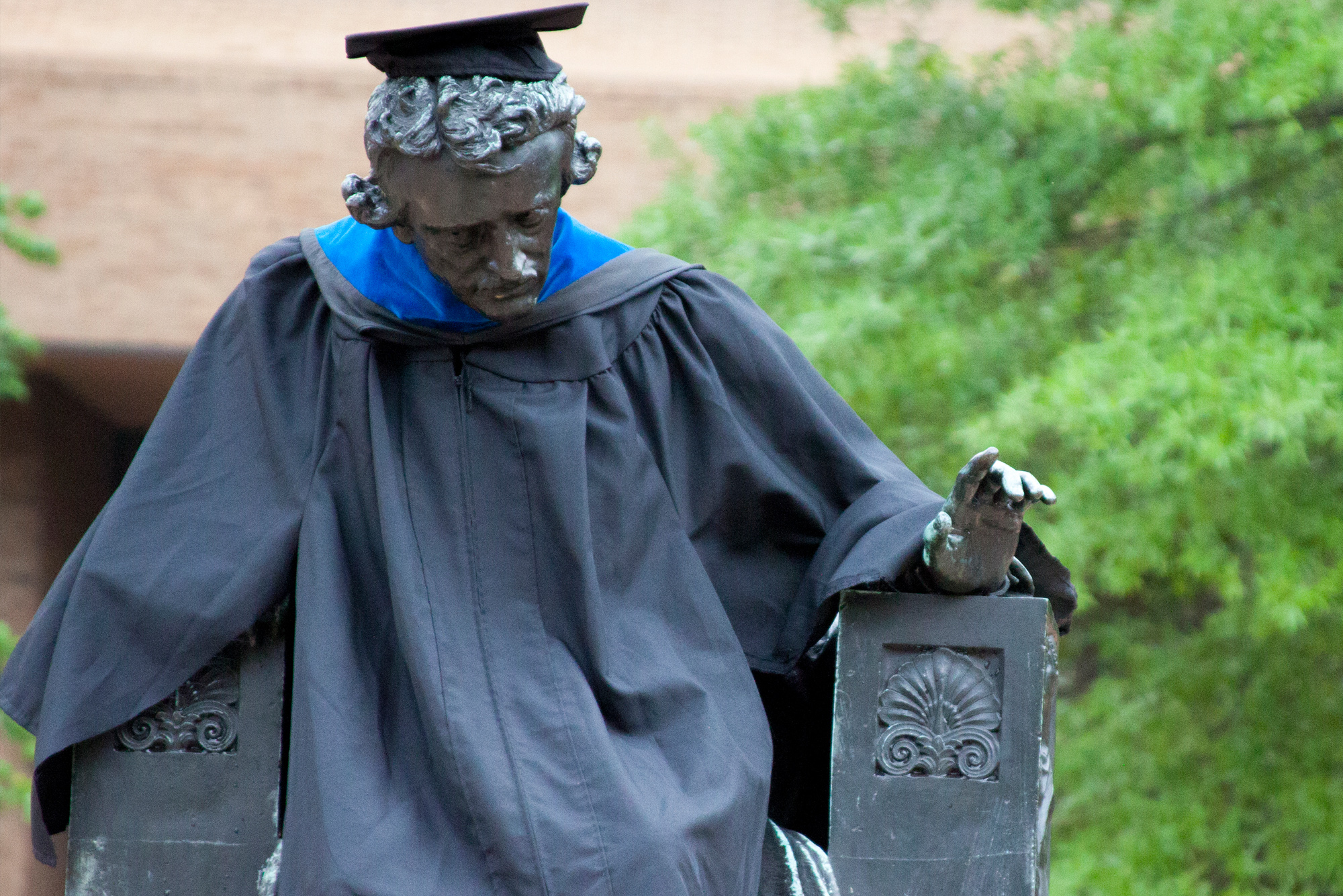 Edgar Allen Poe Statue on the UBalt campus draped in graduation garb