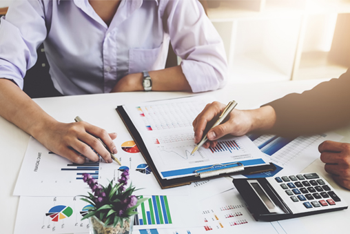 an image portrayal of a two people at a table discussing finances