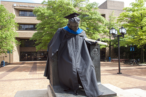 Edgar Allen Poe Statue on the UBalt campus with fall leaves in the background