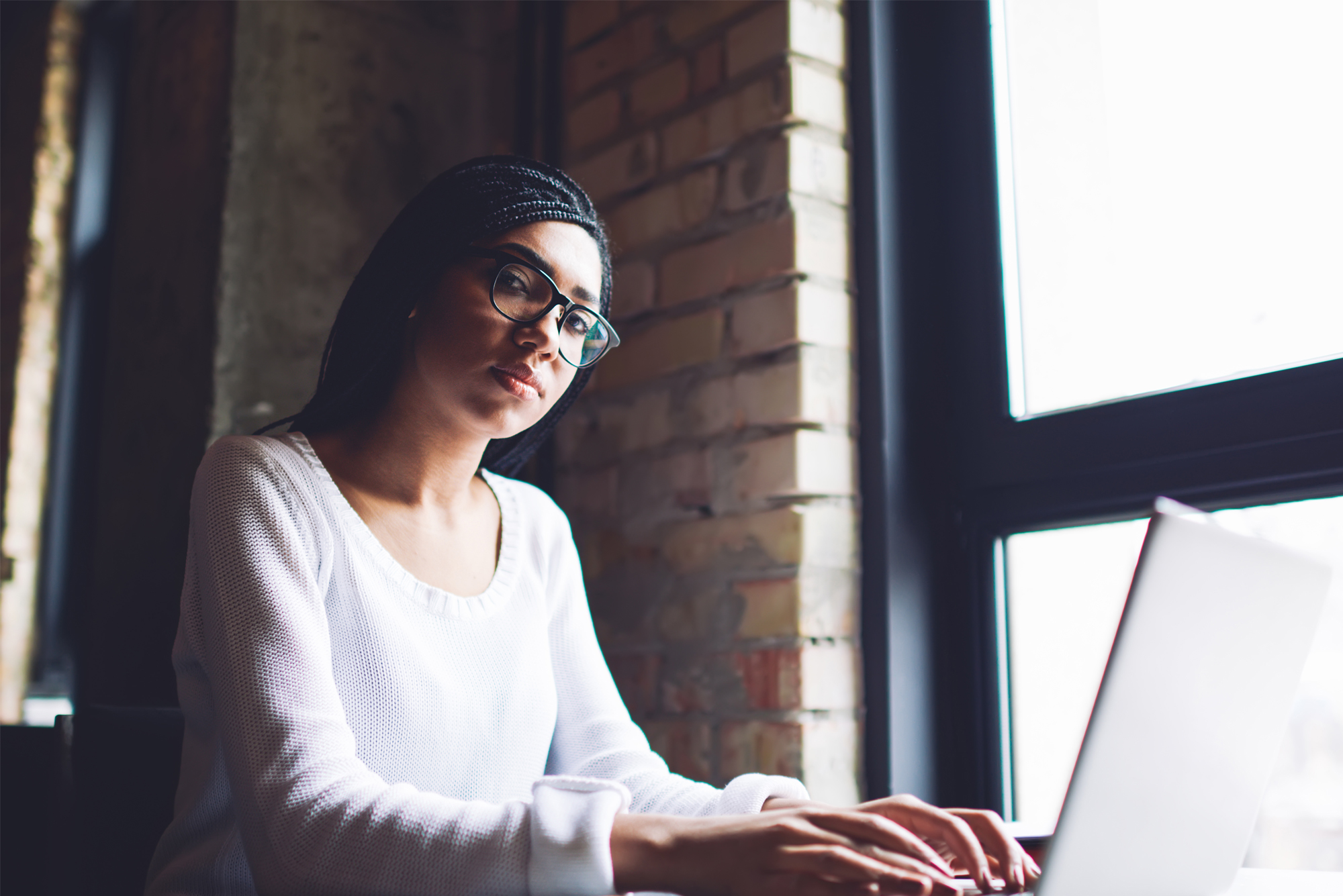 women at a desk on her laptop
